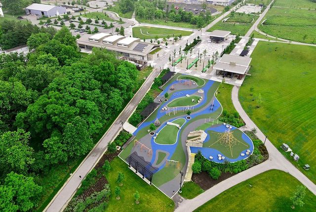 Ariel photo of Switchyard Park, including a visual of the Pavilion, playground, spray pad, shelter, and the B-Line Trail.