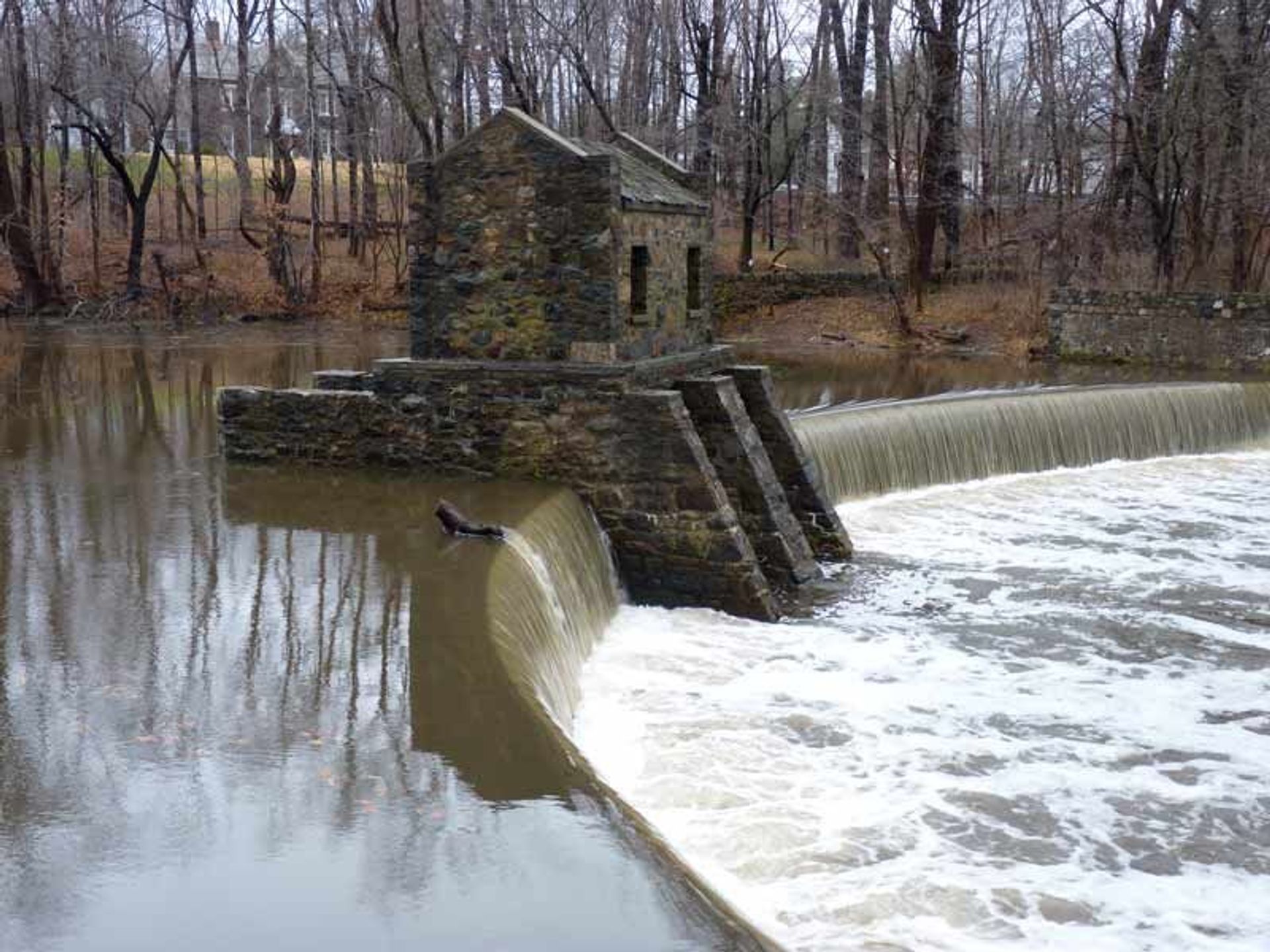 Historic Speedwell Lake Dam on Patriots Path, in Morristown, NJ with the remains of an 18th century iron works opposite the dam;