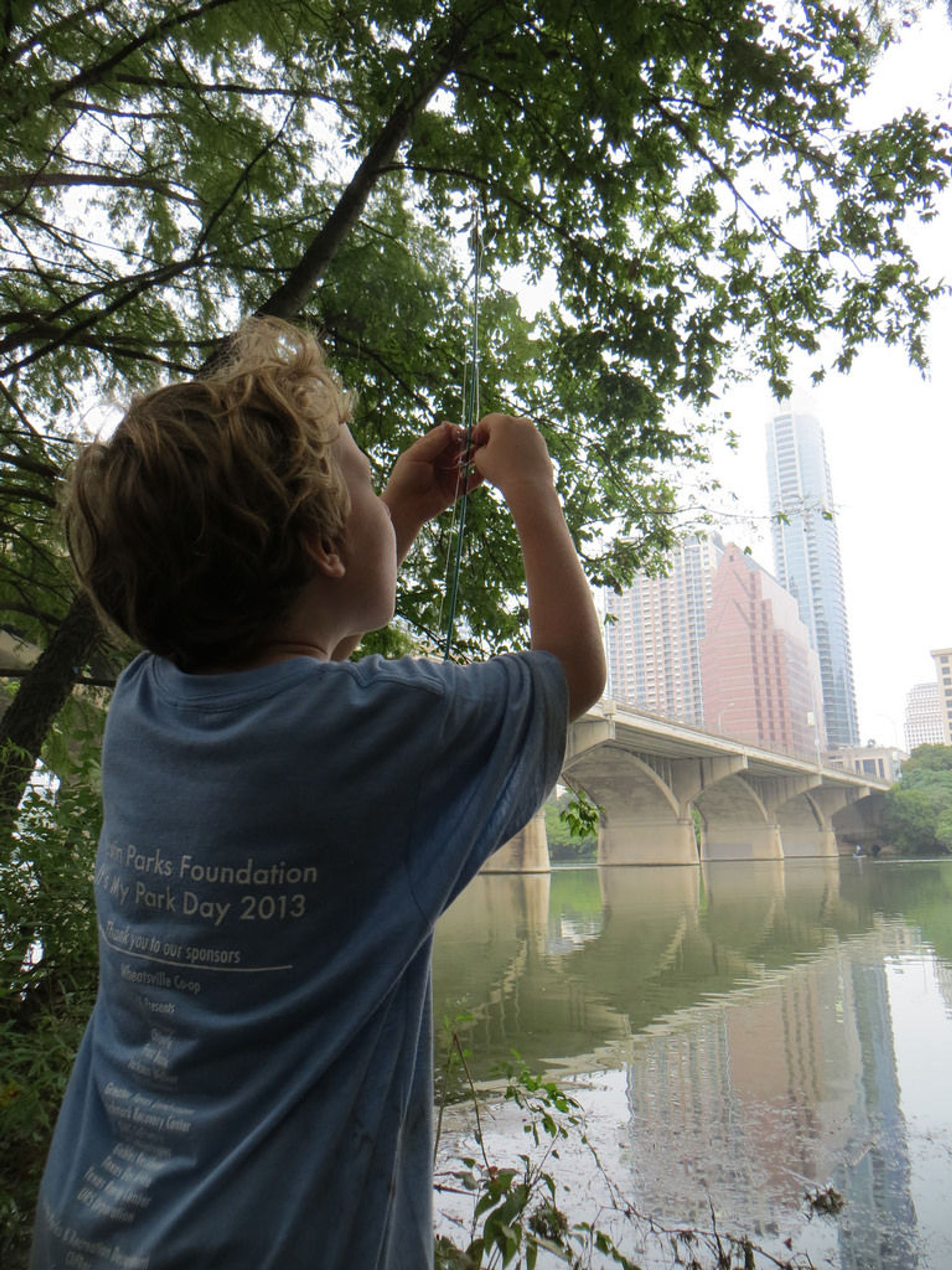 A young angler along the Ann and Roy Butler Hike and Bike Trail on Ladybird Lake in downtown Austin, Texas. Photo by Chris Sheffield.