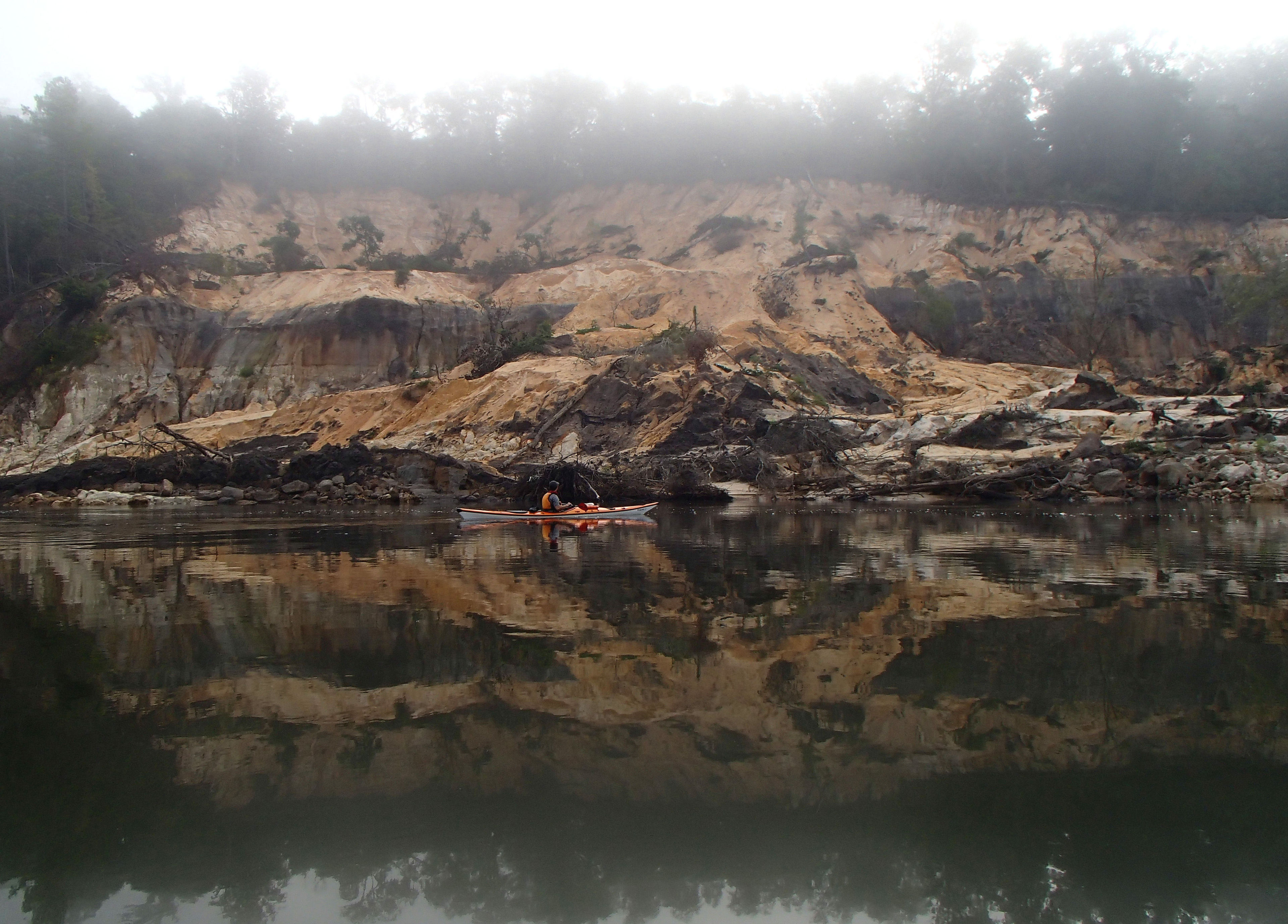 Kayaker by Alum Bluff on a foggy morning. Photo by Doug Alderson.