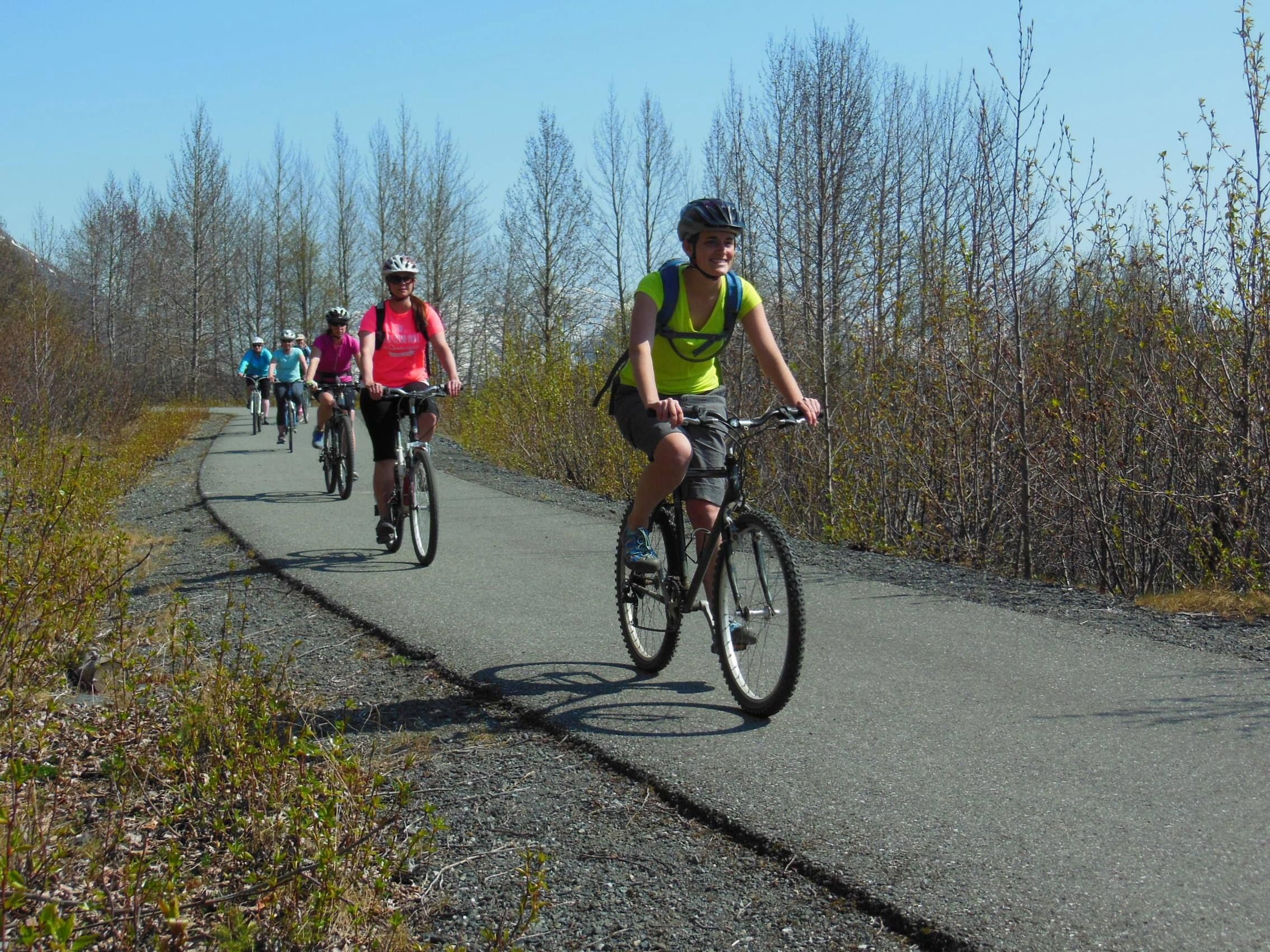 Bicyclists enoying spring sunshine on the Bird-to-Gird Trail near Anchorage. Photo by Susan Sommer.