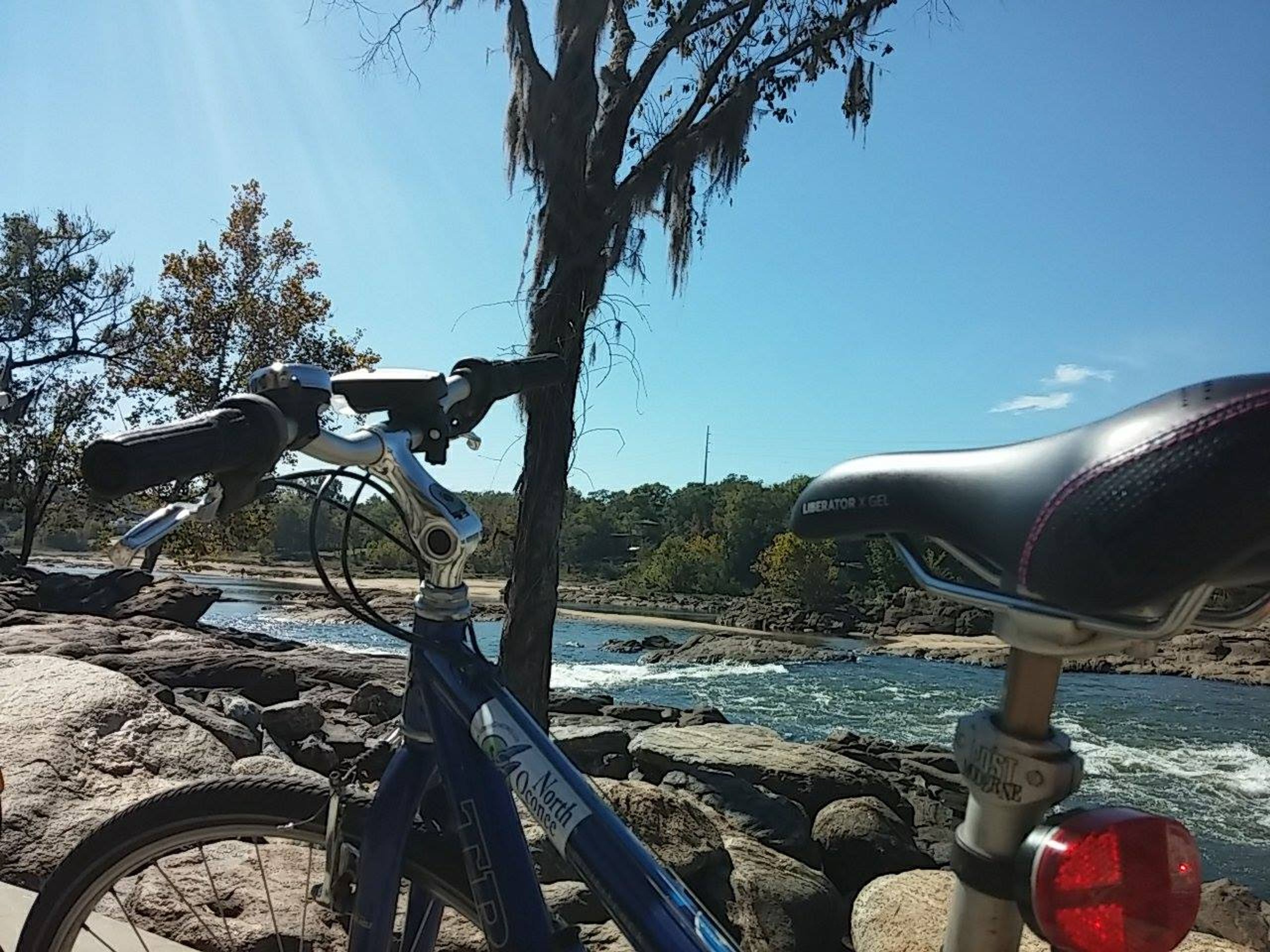 Bike resting on railing at the edge of the Chattahoochee River. Photo by Tracie Sanchez.