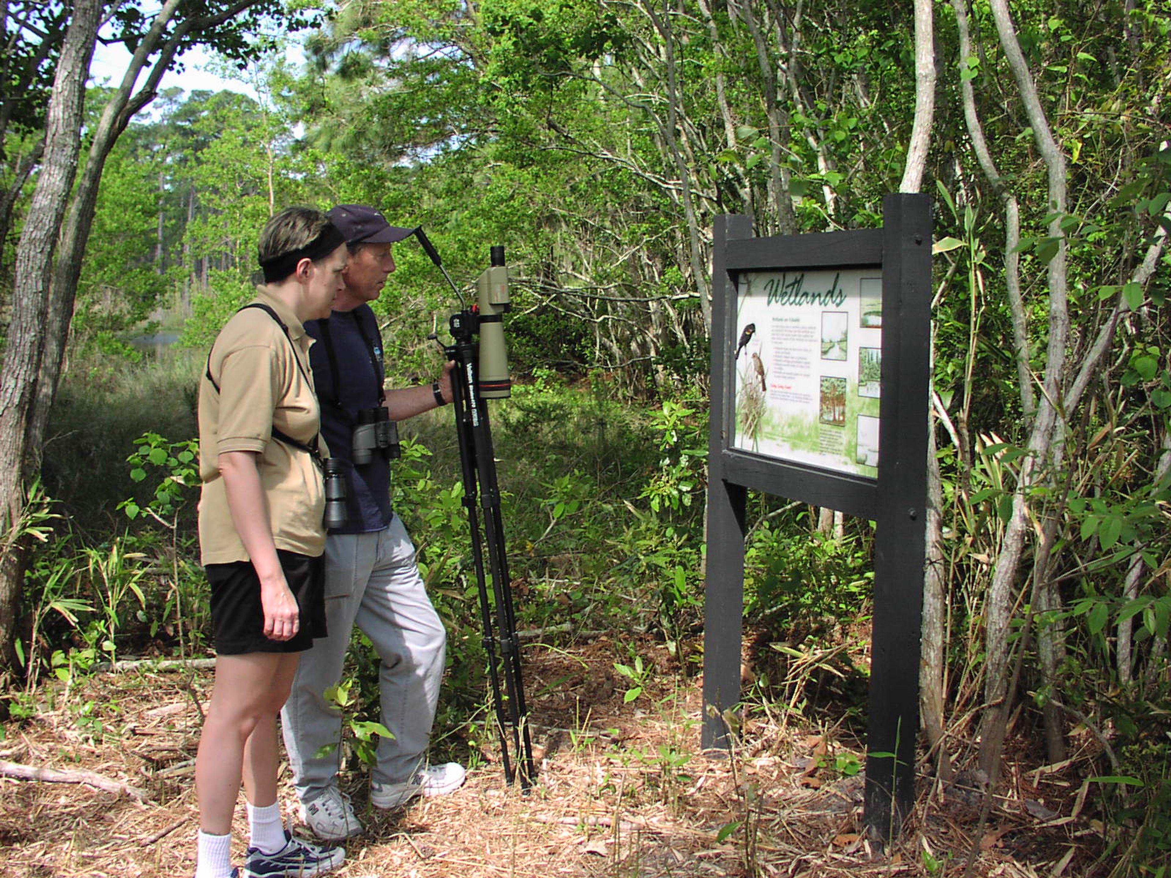 Vistors using one of our interpretive signage.