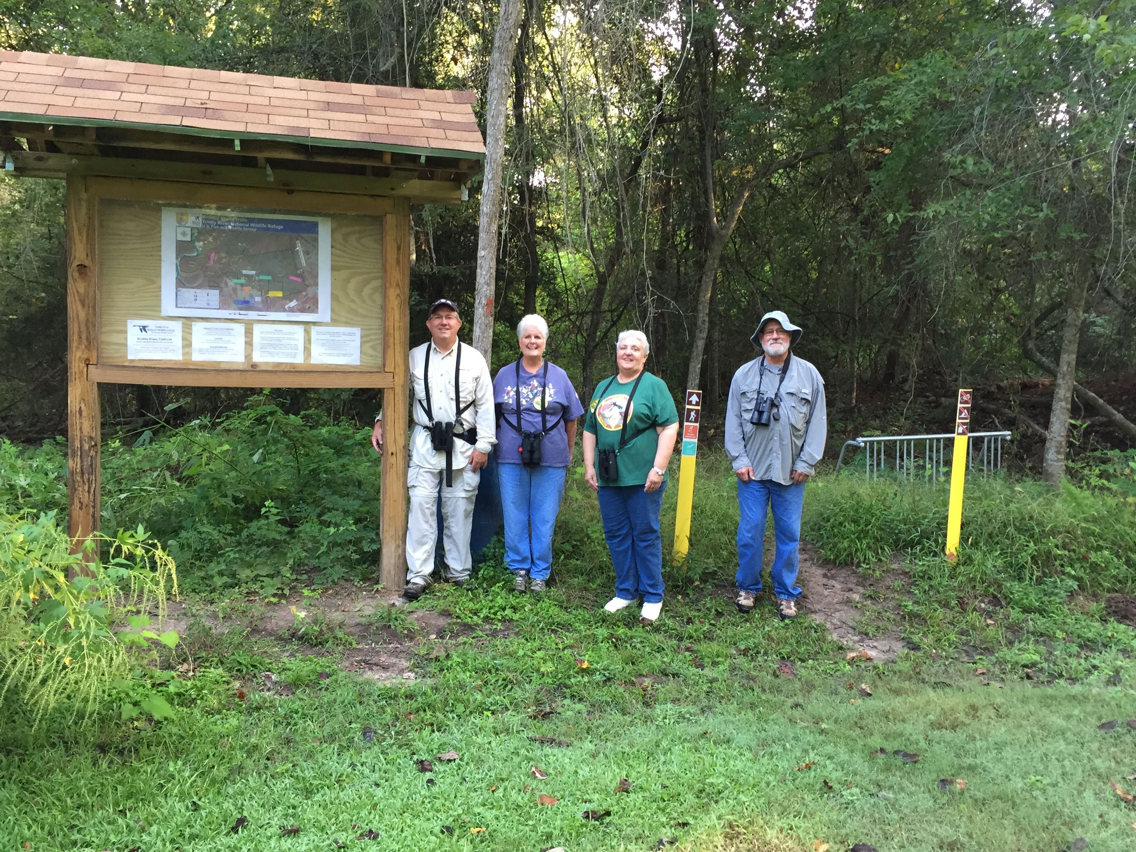 Lower Trinity Valley Bird Club on a Field Trip posing in front of Knobby Knees Trailhead Kiosk