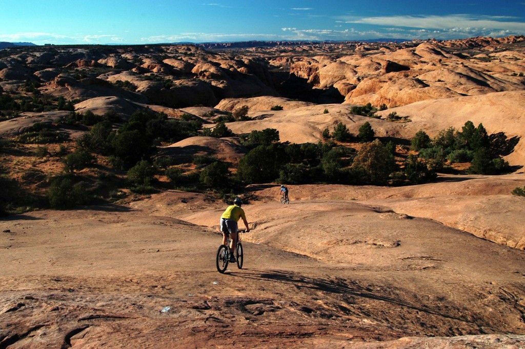 Mountain Bikers on slickrock bike trail in Moab, UT. Photo by Wikicommons.