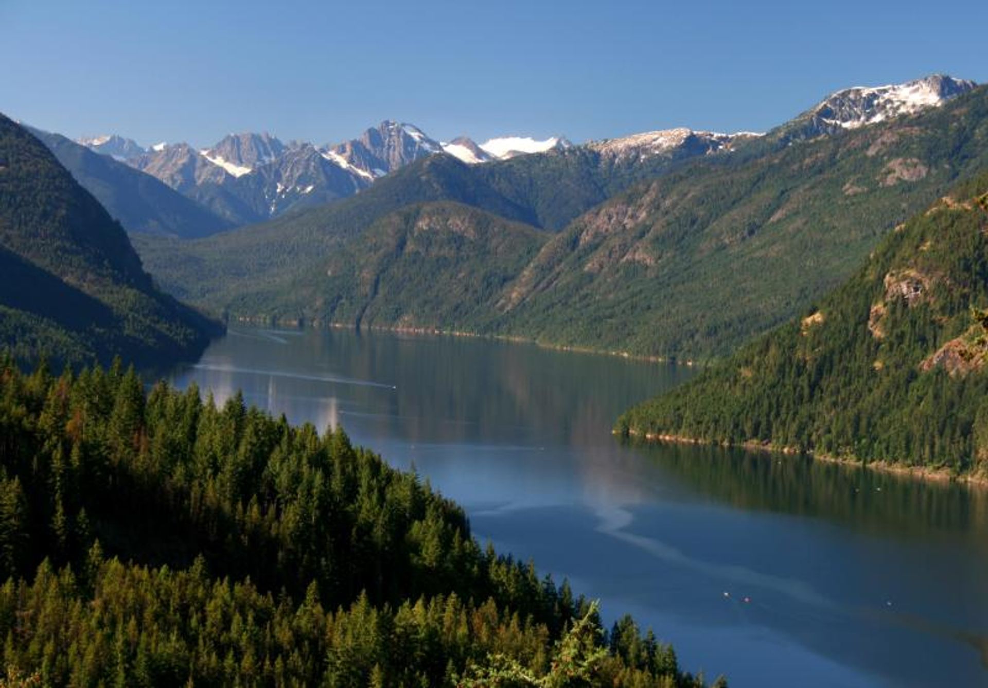 Glacier-covered peaks rise above the blue waters of Ross Lake. Photo by Andy Porter/NPS.