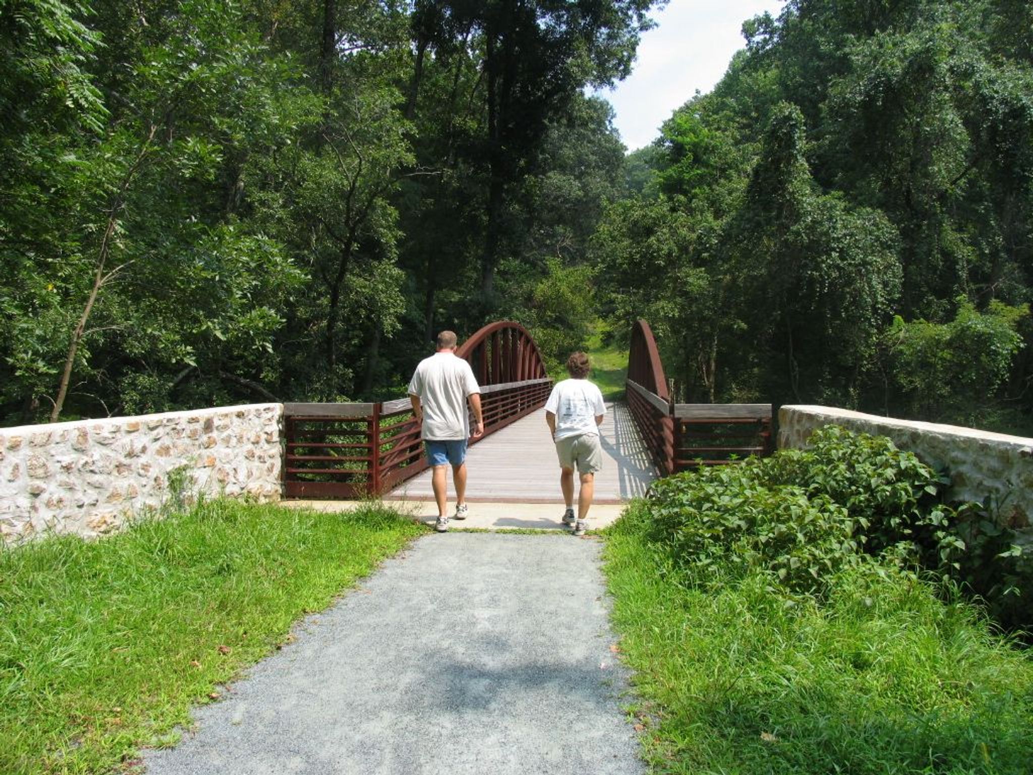 Walking over a pedestrian bridge on the Pomeroy and Newark Rail Trail. Photo by Avery Dunn.