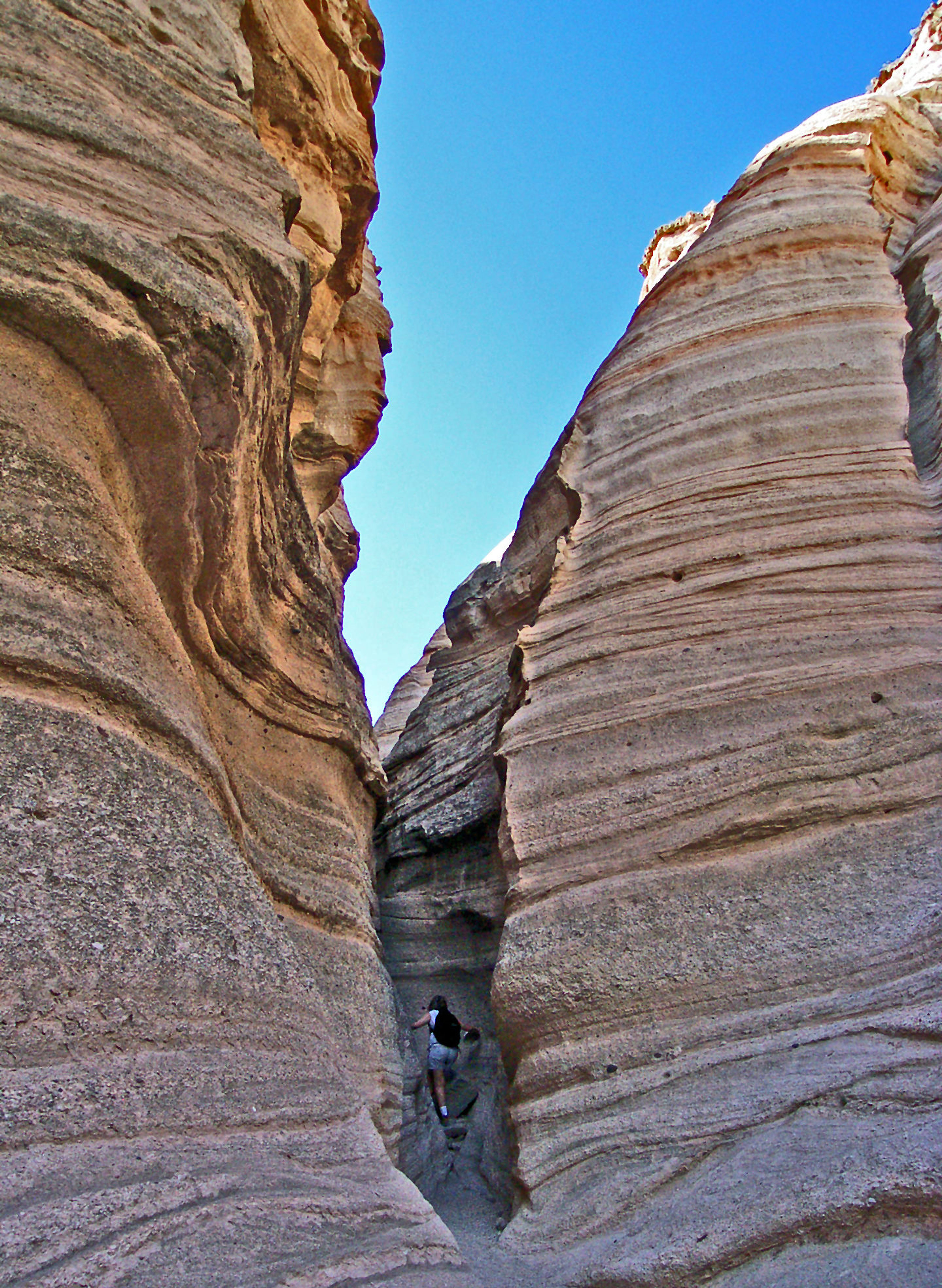 Hiker follows Tent Rocks Trail into the slot canyon. Photo by Stephen Ausherman.