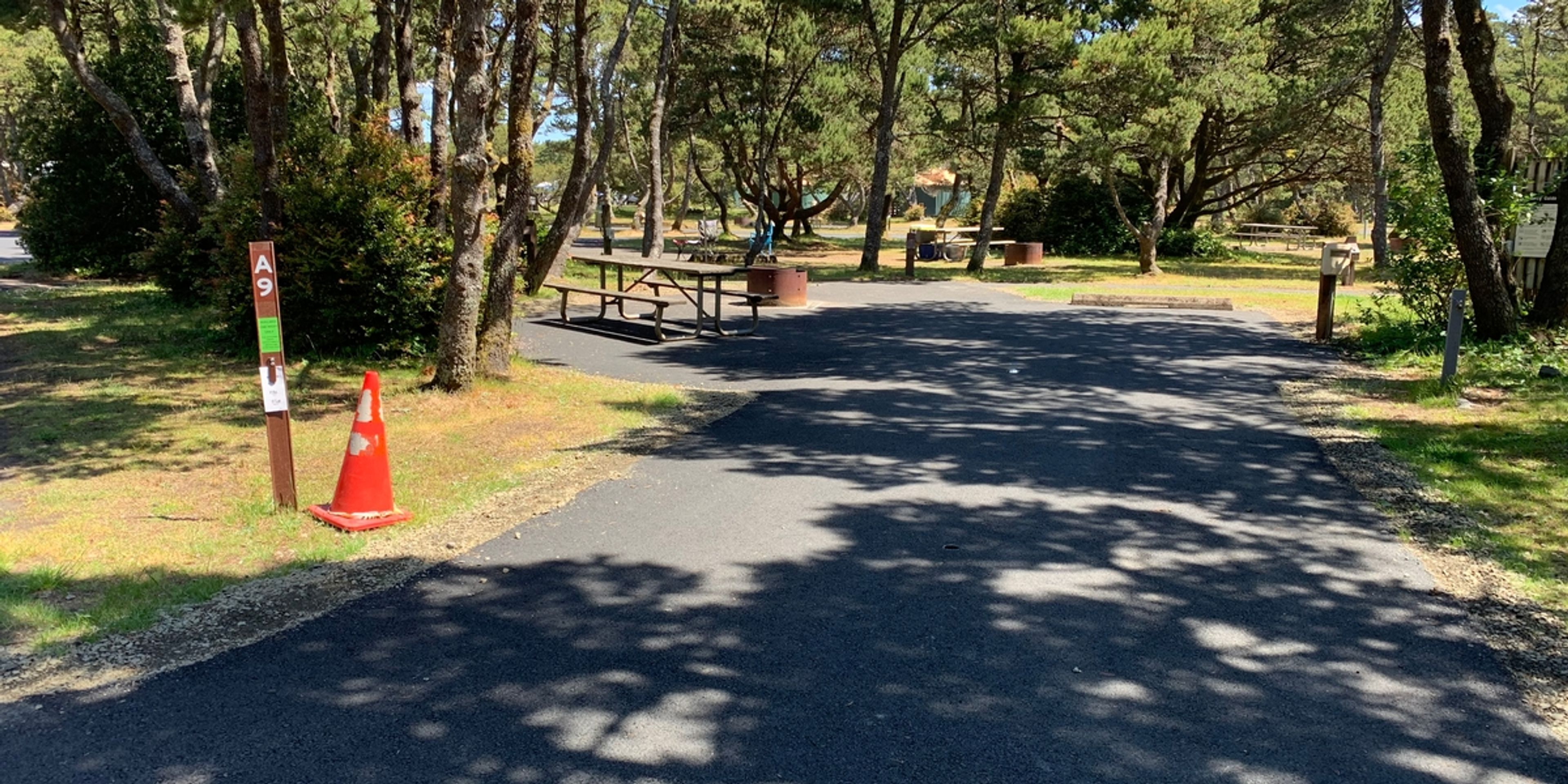 Campsite A9 is an accessible paved site with fire ring and picnic table. This site is near the accessible restroom and connects to the restroom path.