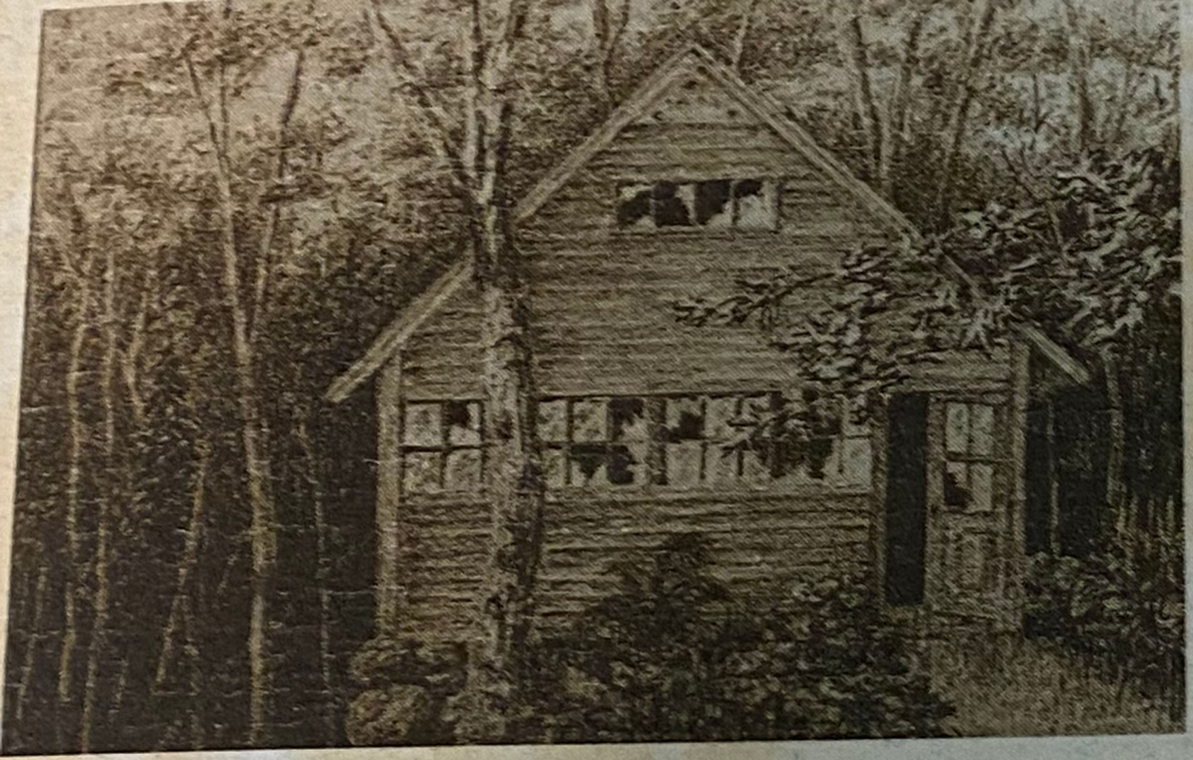 A black and white photo of the pump house with broken windows.