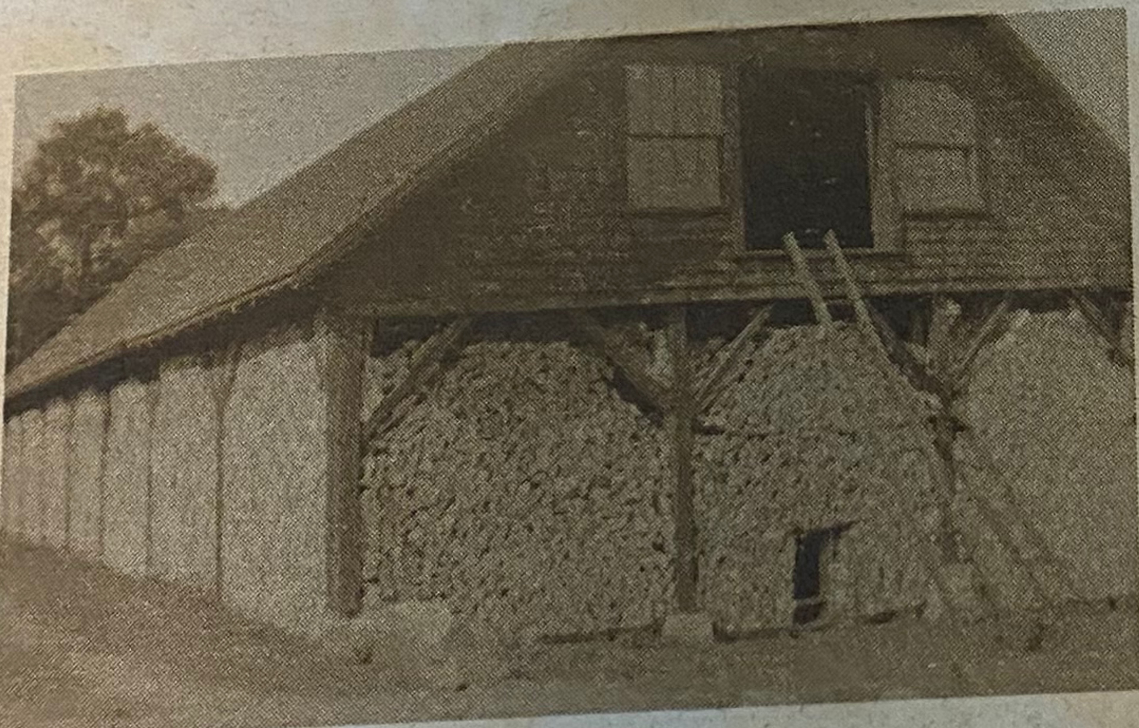 A black and white photo of the old woodshed.