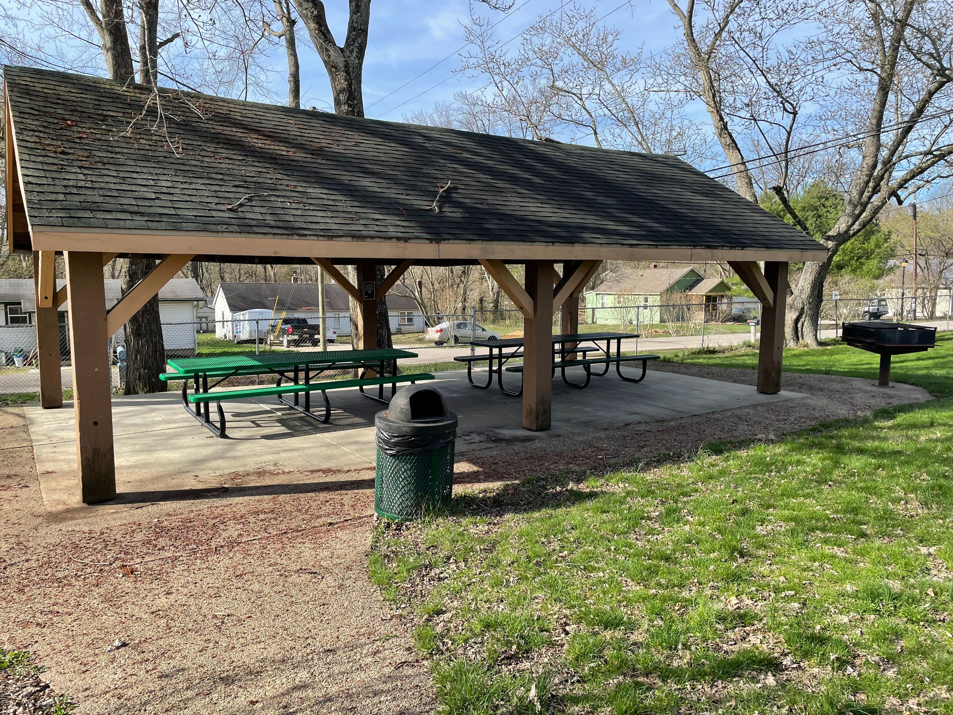 Broadview Park Picnic Shelter with a grill, trashcan, and 2 picnic tables.