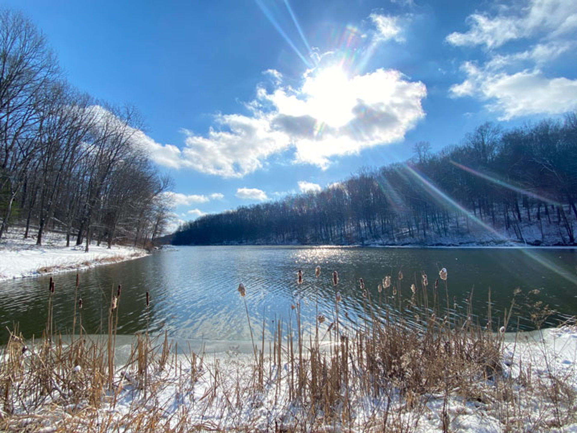 barkcamp state park overlooking the lake on a winter day with snow on the banks and the sun shining