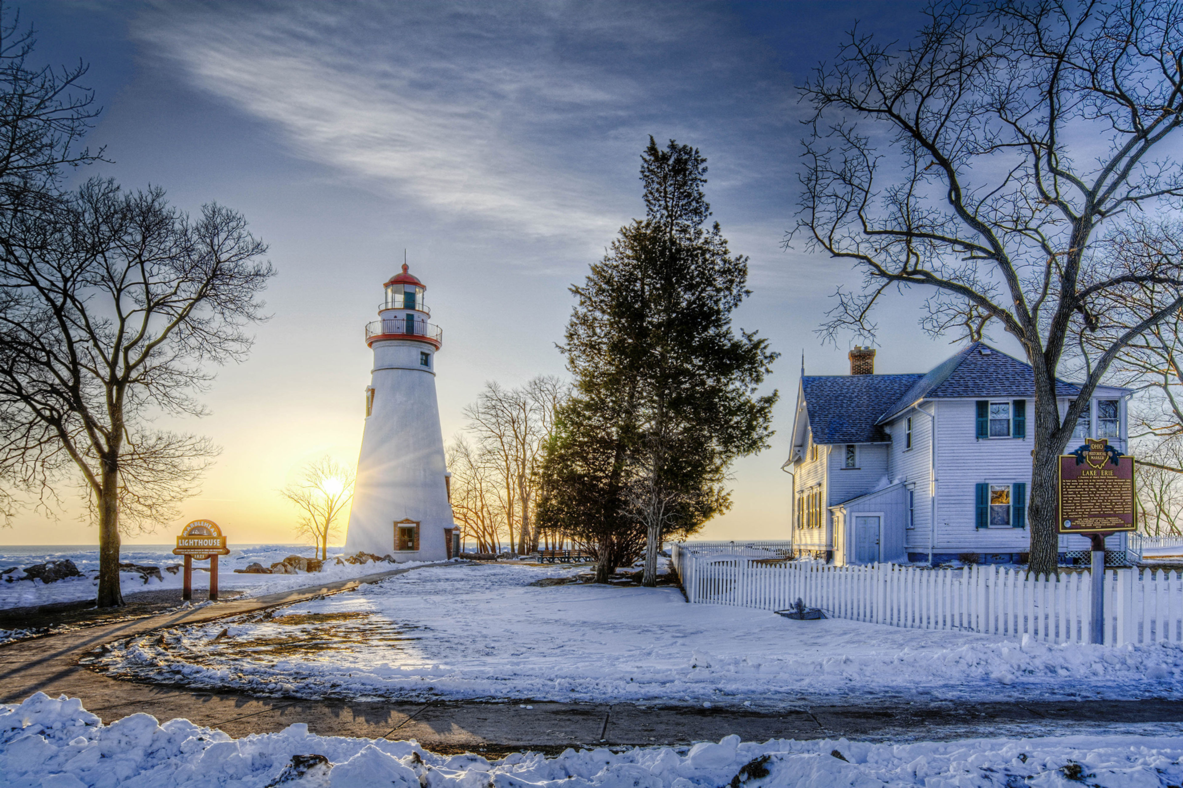 The historic Marblehead Lighthouse in Northwest Ohio sits along the rocky shores of Lake Erie. Seen here at sunrise  in winter with snow and ice on the ground.