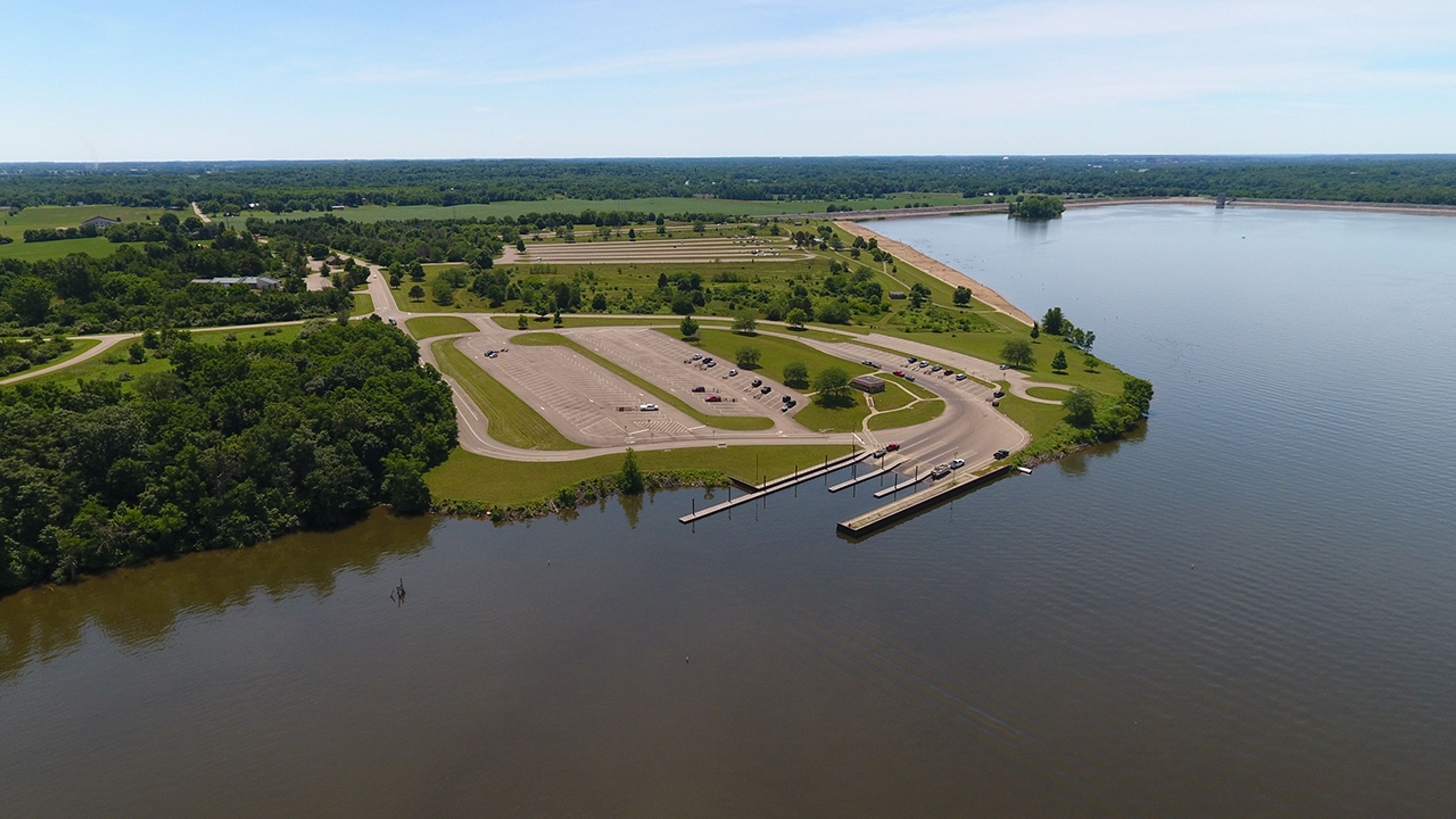 An aerial view of the parking lot and boat launch into a lake at Buck Creek State Park.