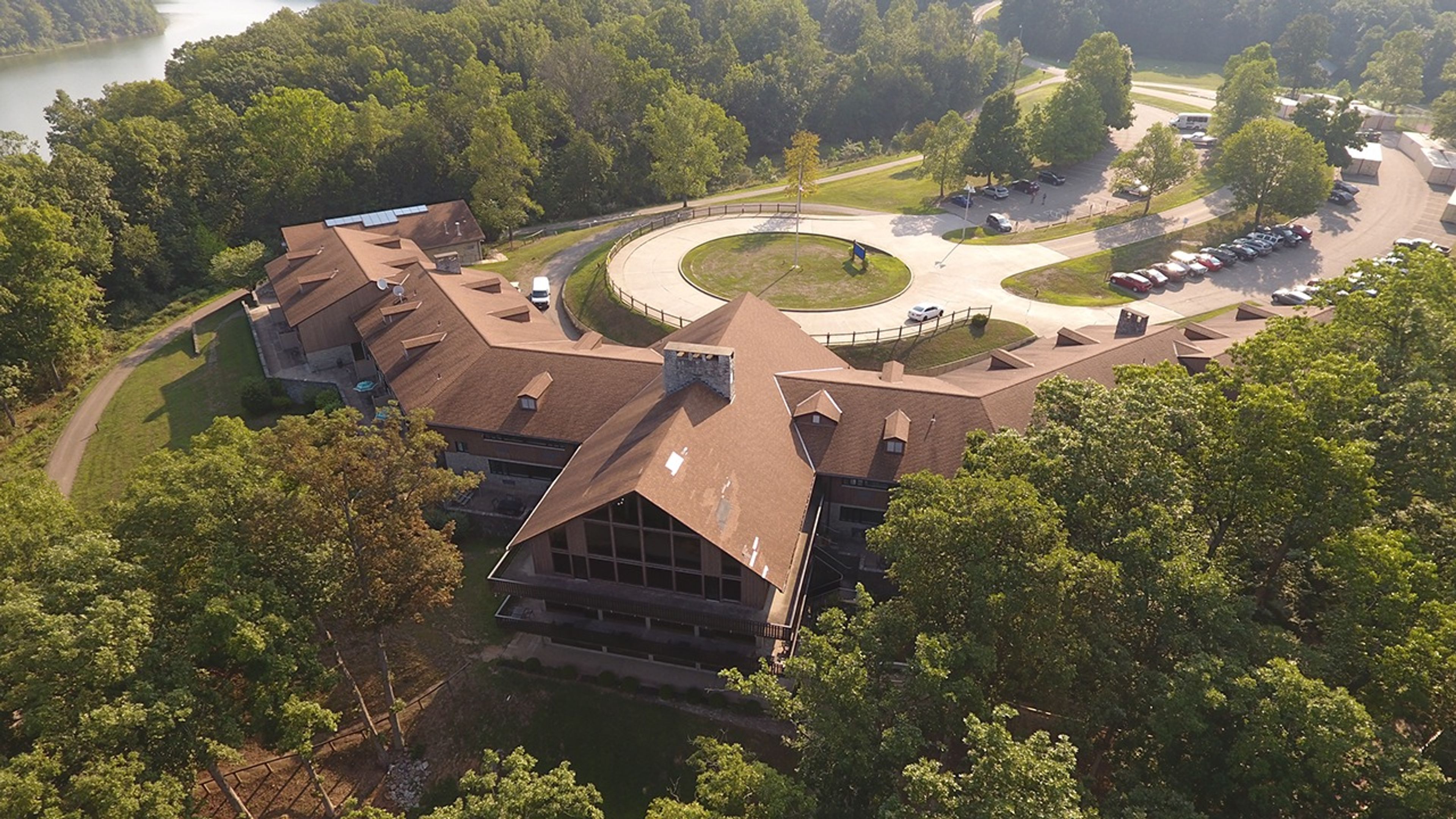 Aerial view of the back of the Burr Oak lodge surrounded by trees at Burr Oak State Park.