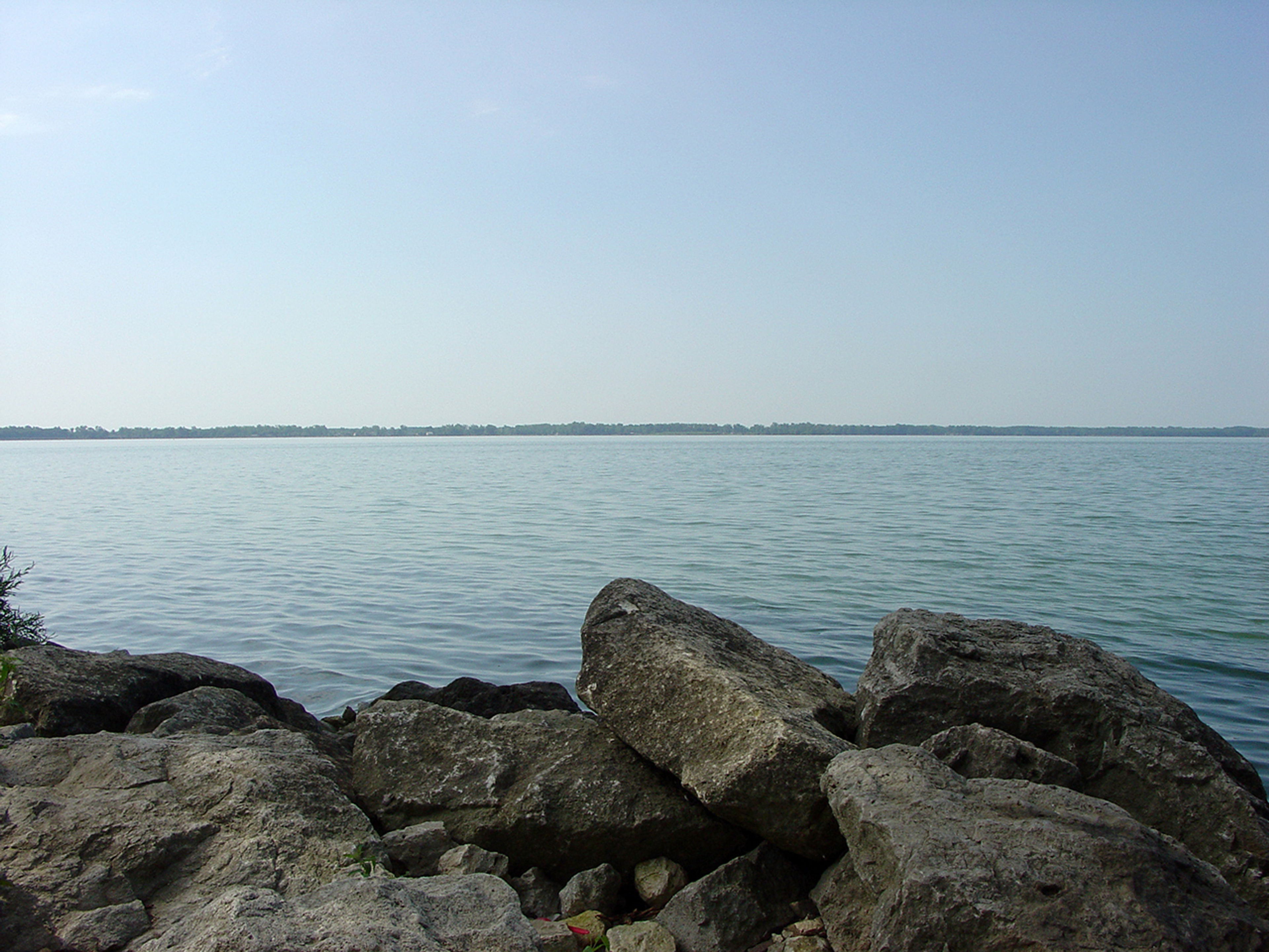 A large rocks next to a body of water at Grand Lake St Marys State Park