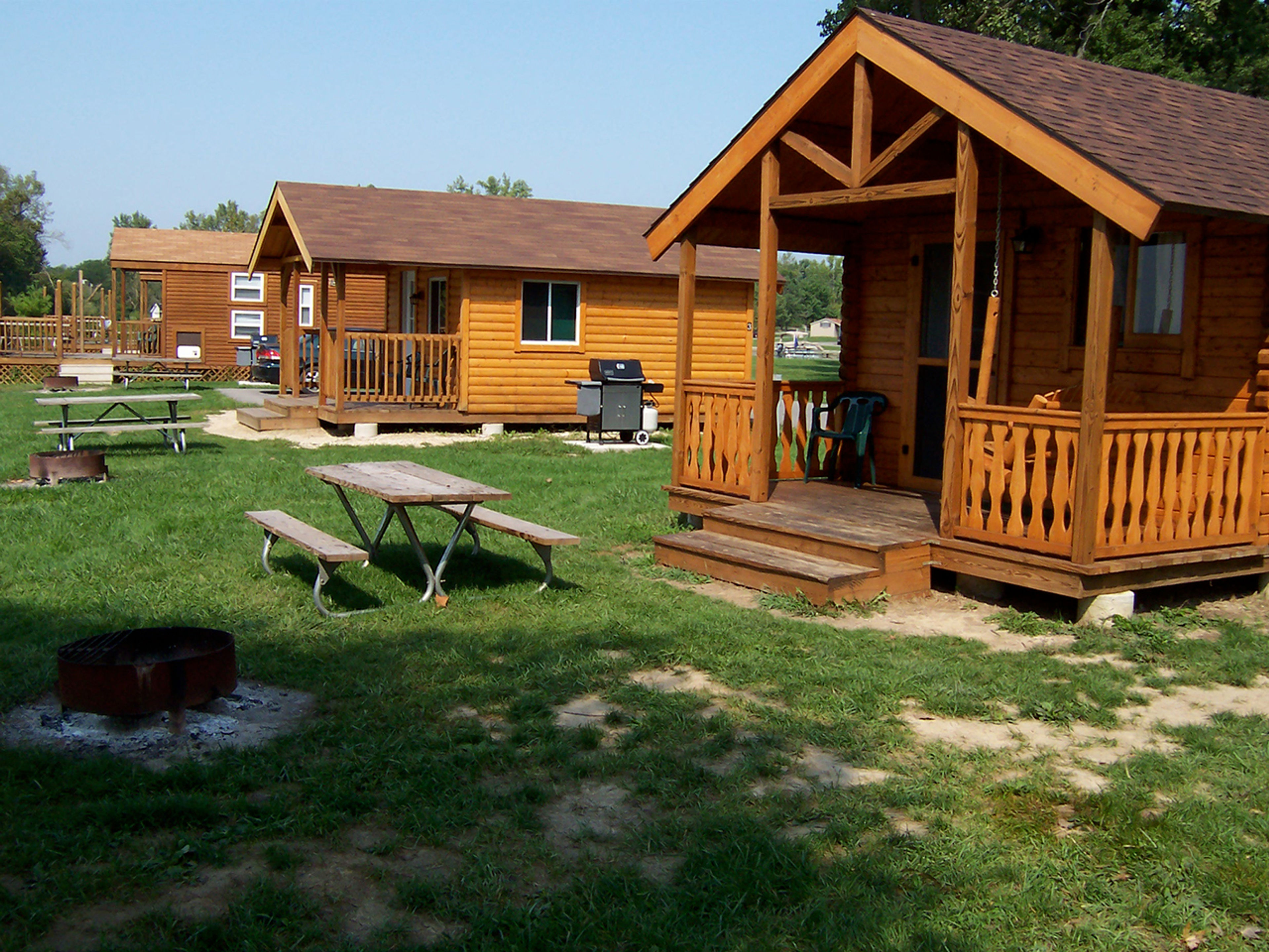 A group of three cabins in a park at Grand Lake St Marys State Park