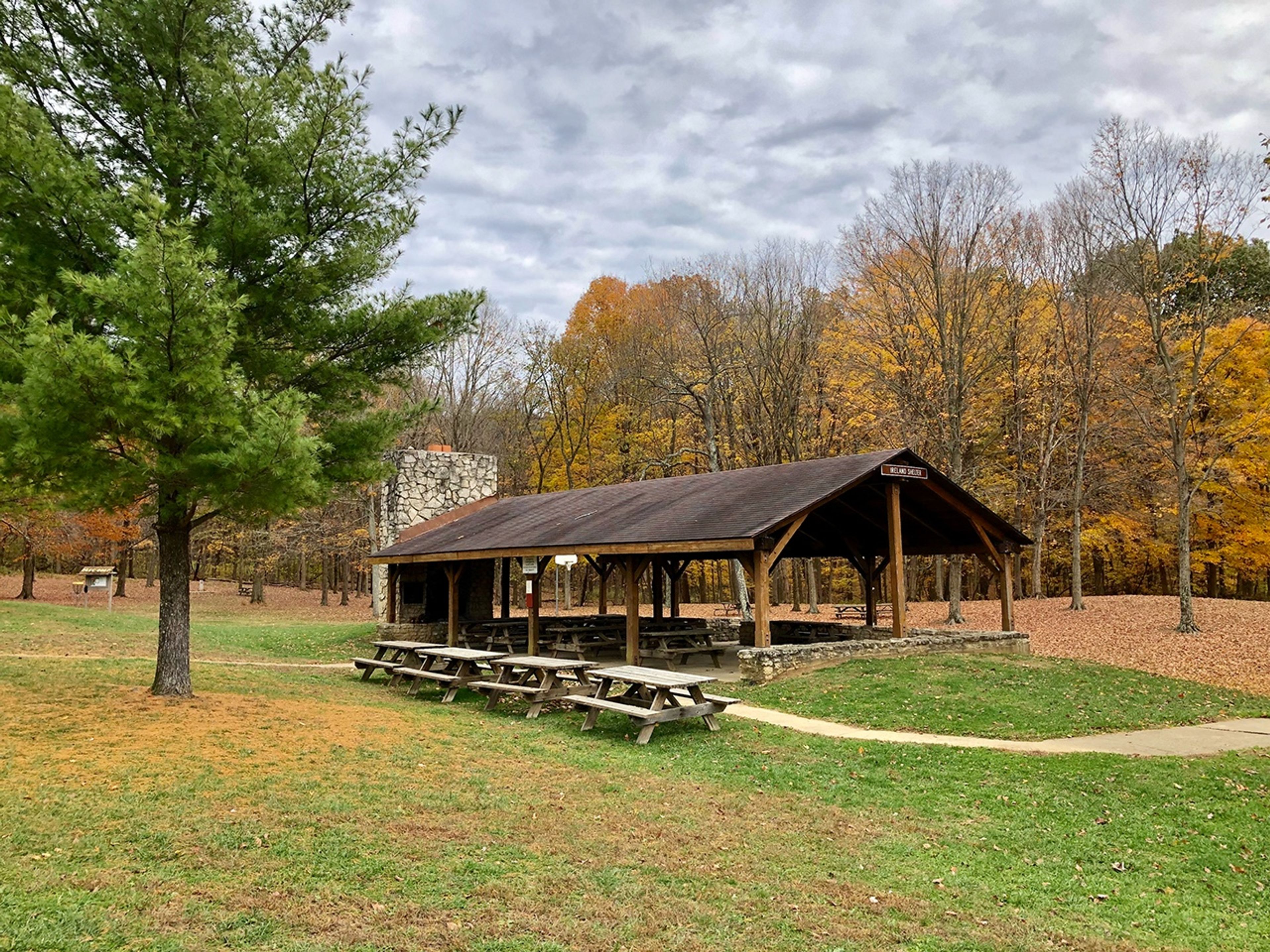 A picnic area with benches and a shelter house in the woods at Great Seal State Park