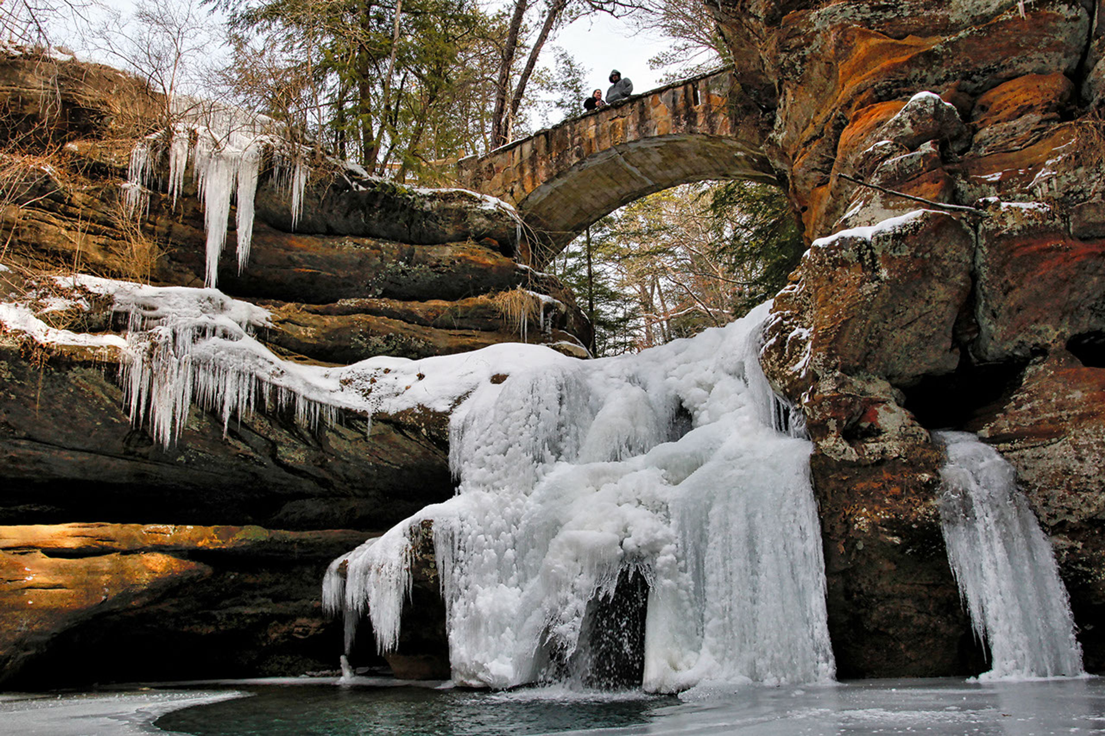 A bridge over a frozen waterfall at Hocking Hills State Park