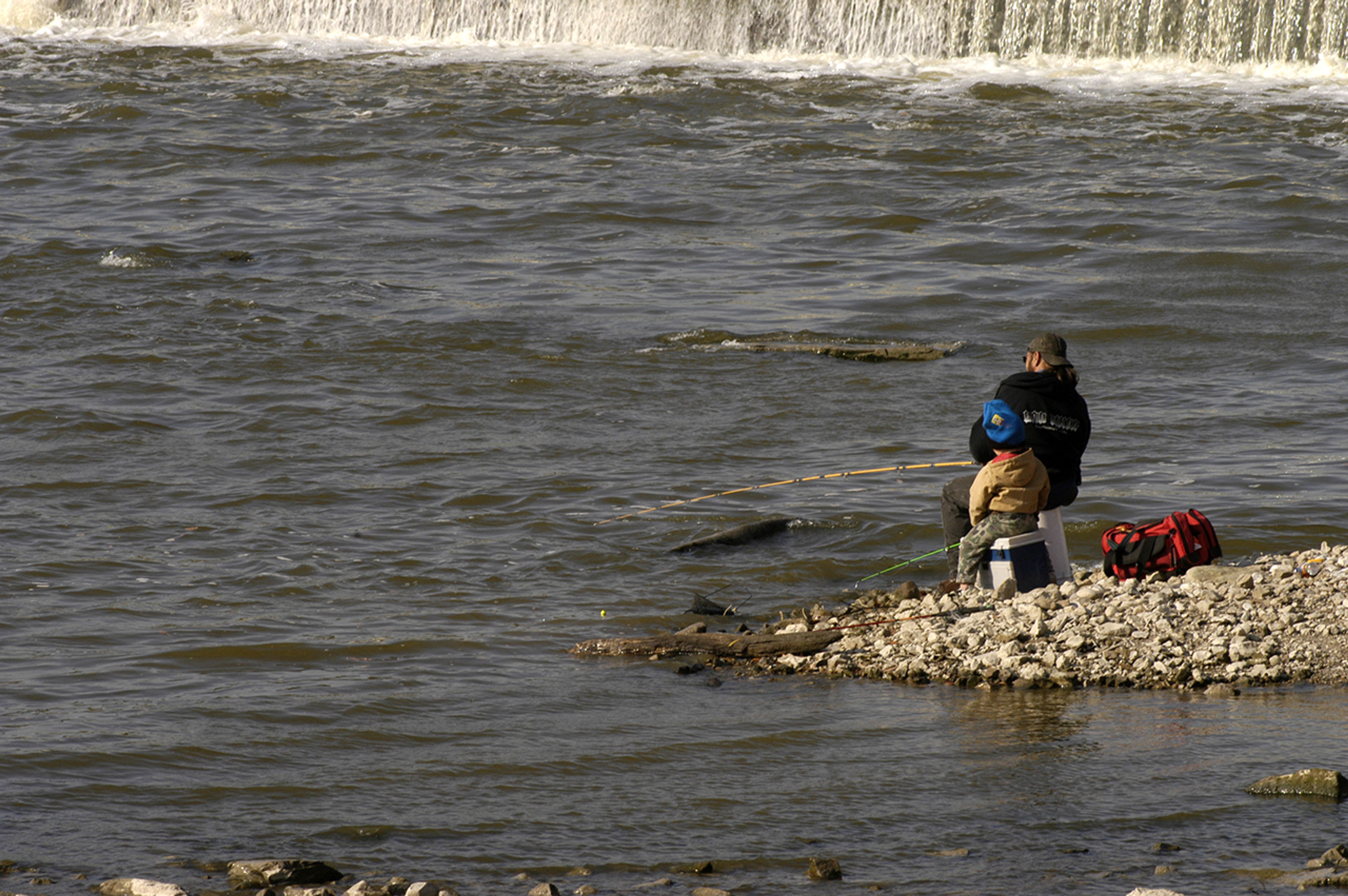 A person and child fishing in a river at Independence Dam State Park