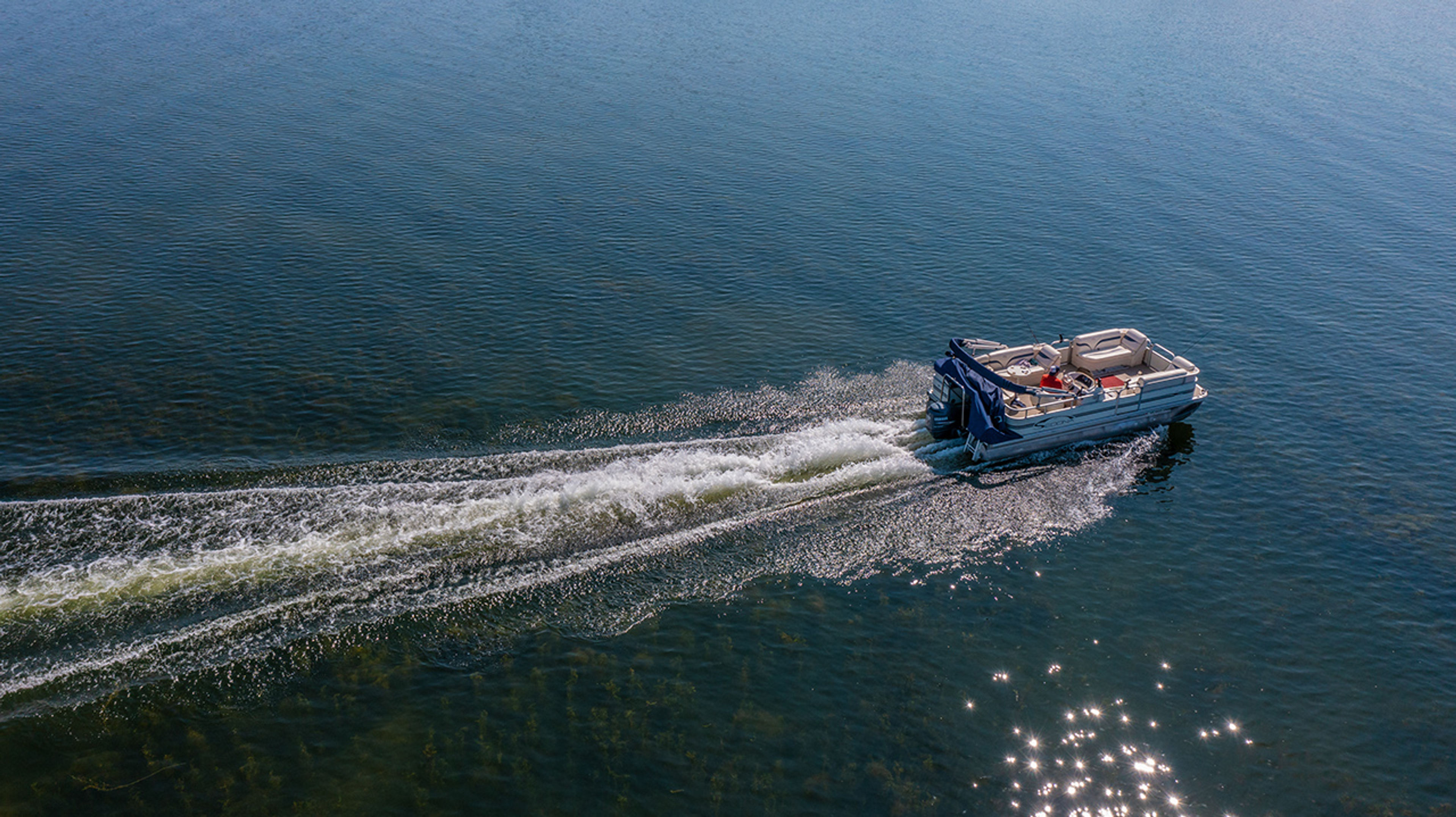 Aerial view of a boat driving on the water at Indian Lake State Park