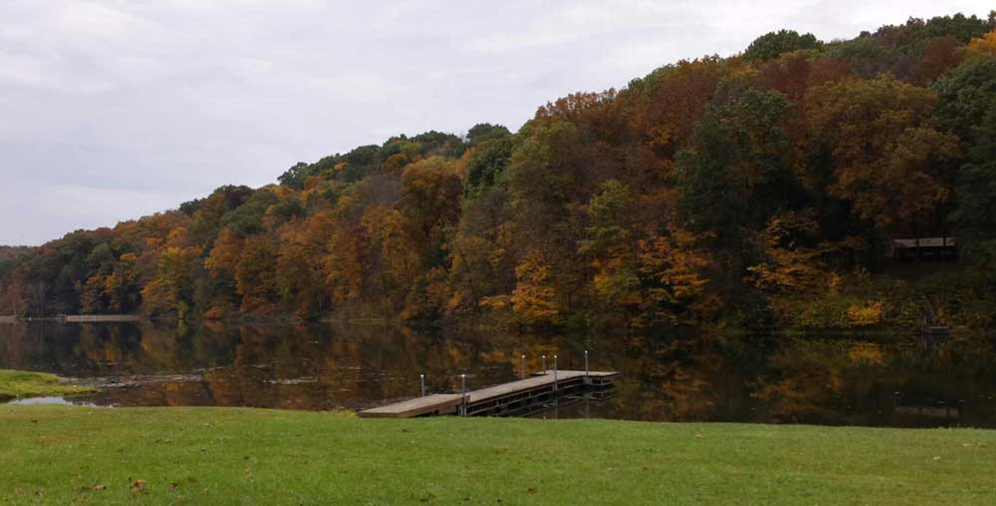 A dock on a body of water with trees at Jefferson Lake State Park