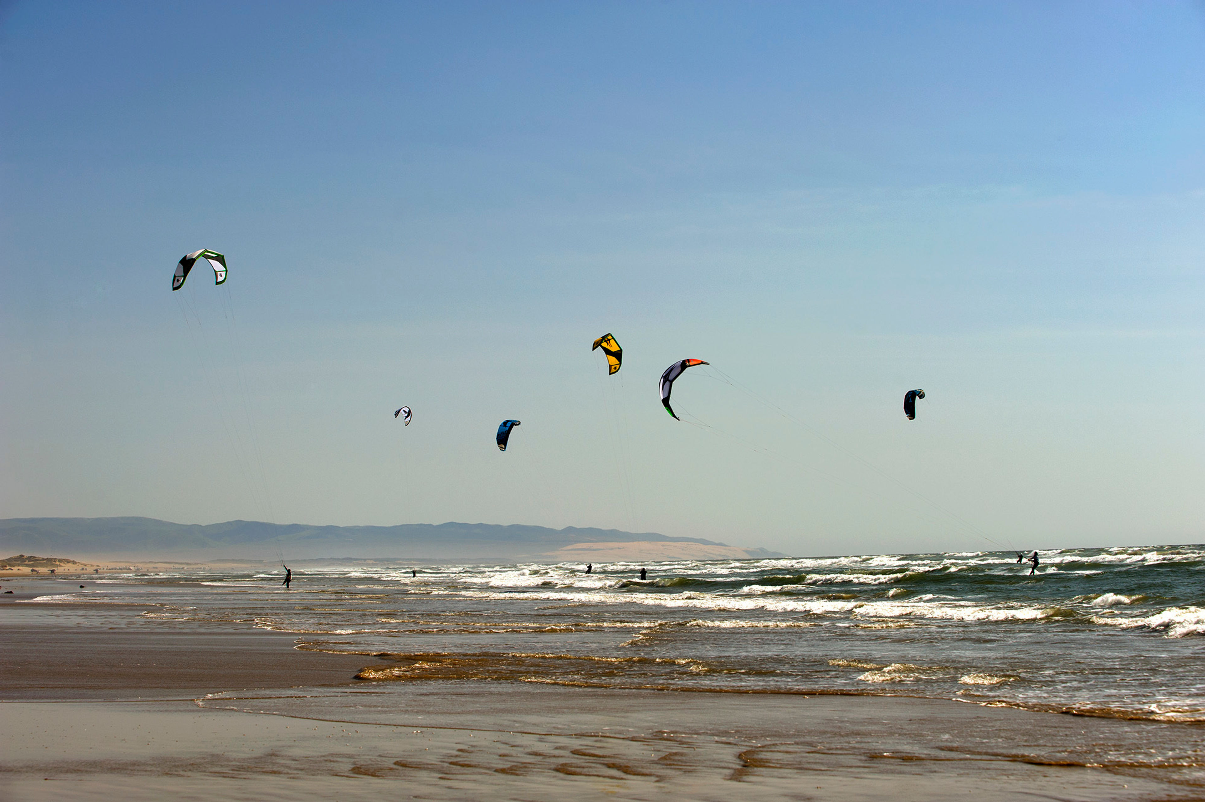 Kite surfers just off the beach.