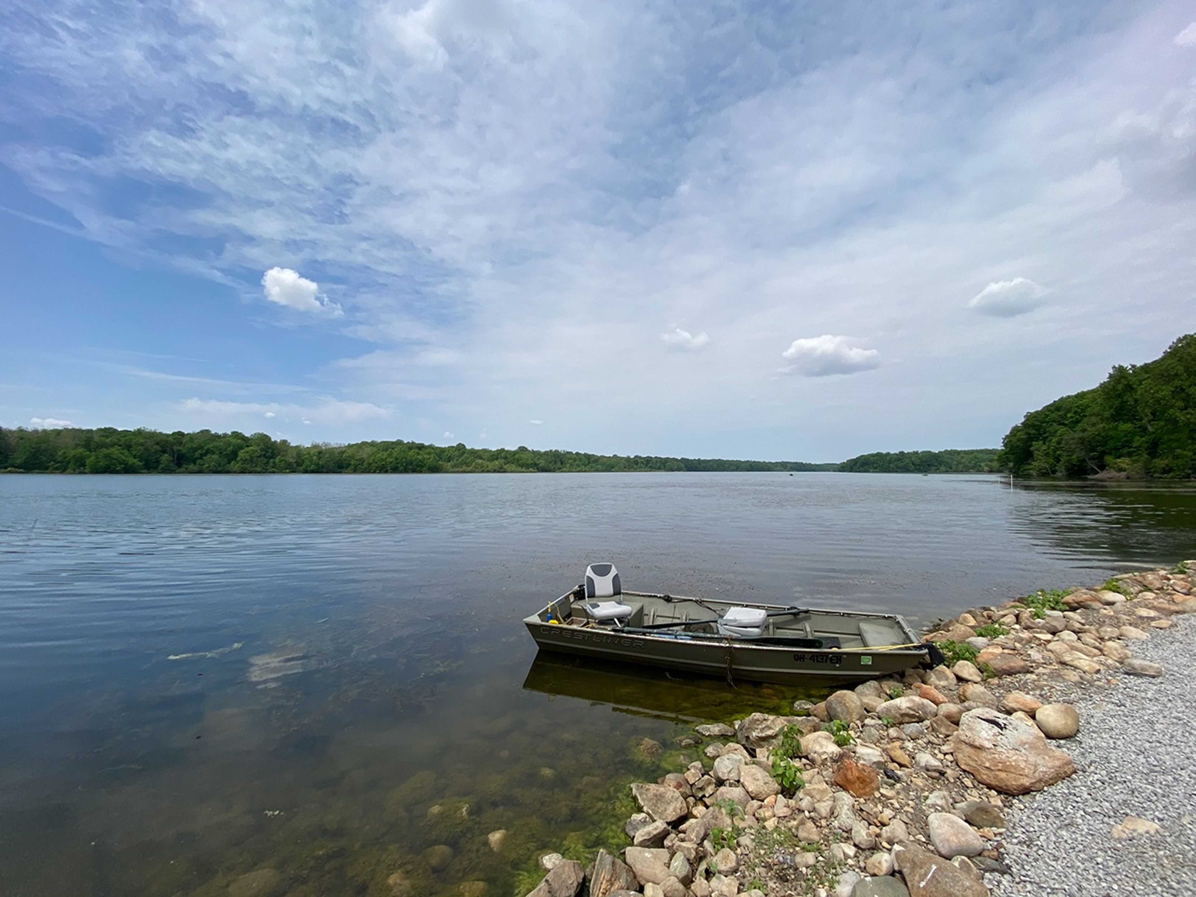 A boat on the water near a rocky shore at Kiser Lake State Park