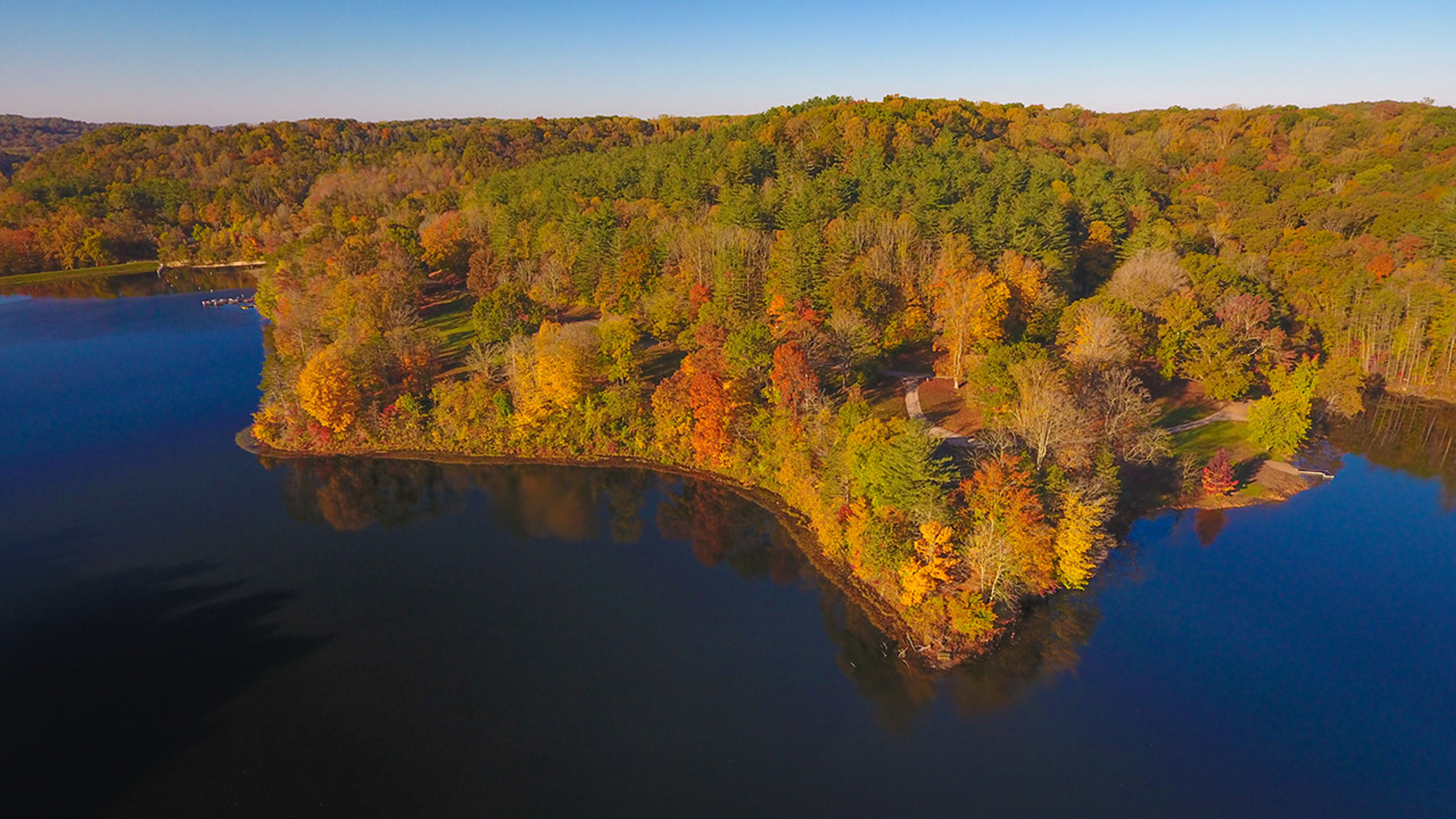 An aerial view of a lake surrounded by trees at Lake Hope State Park