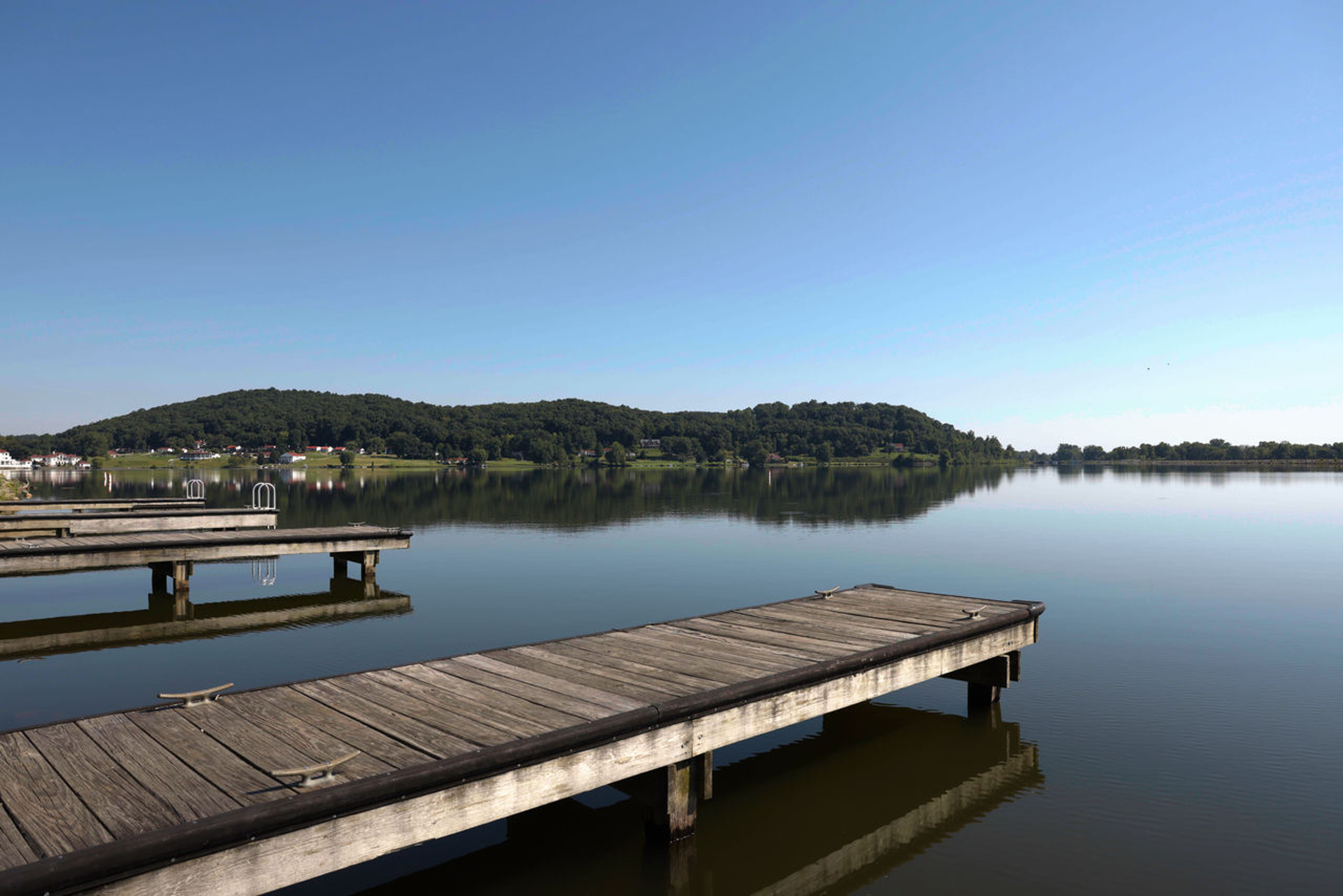 Four wooded docks on a body of water at Lake White State Park