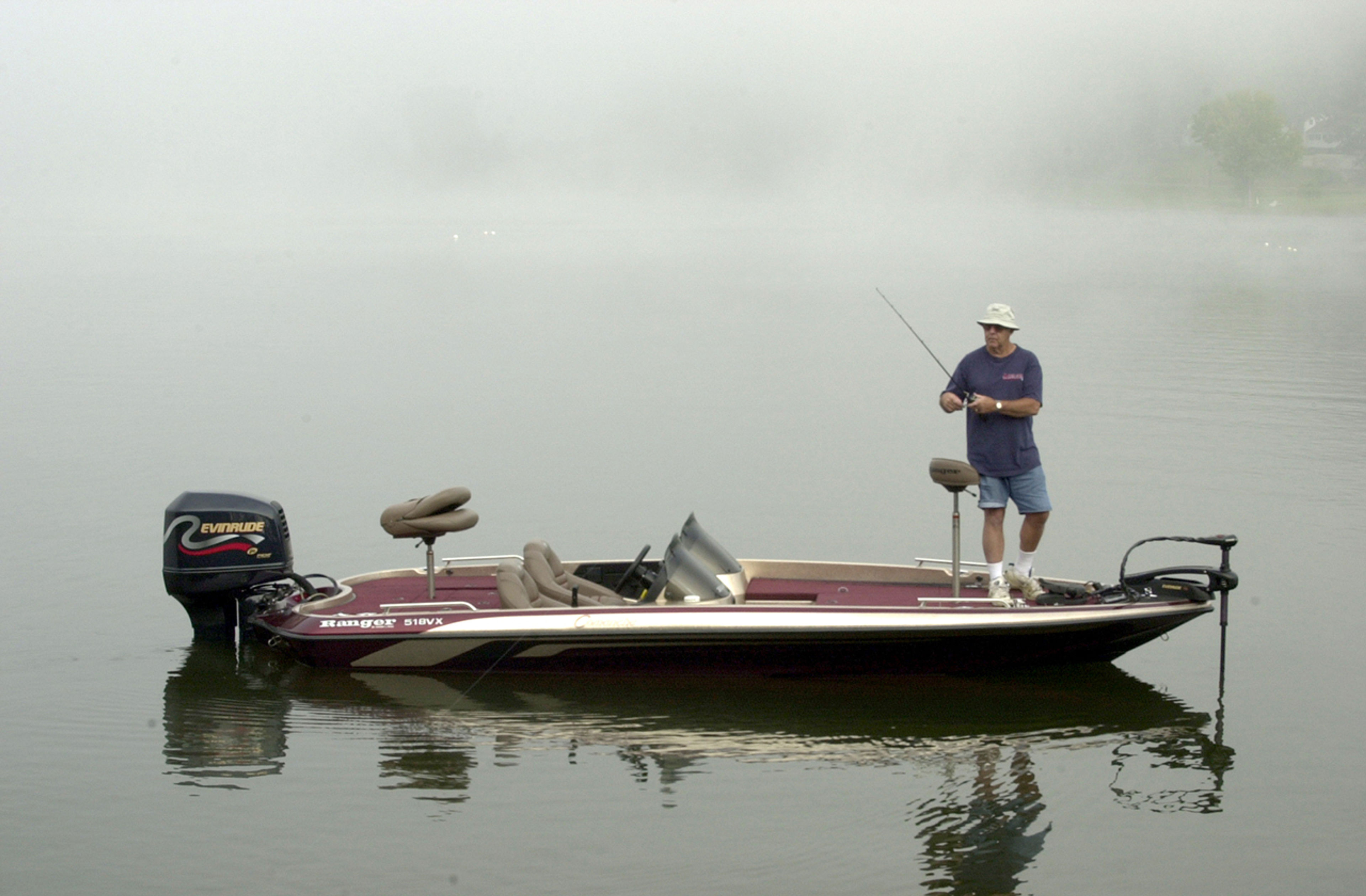 Man fishing in a boat on the water at Lake White State Park