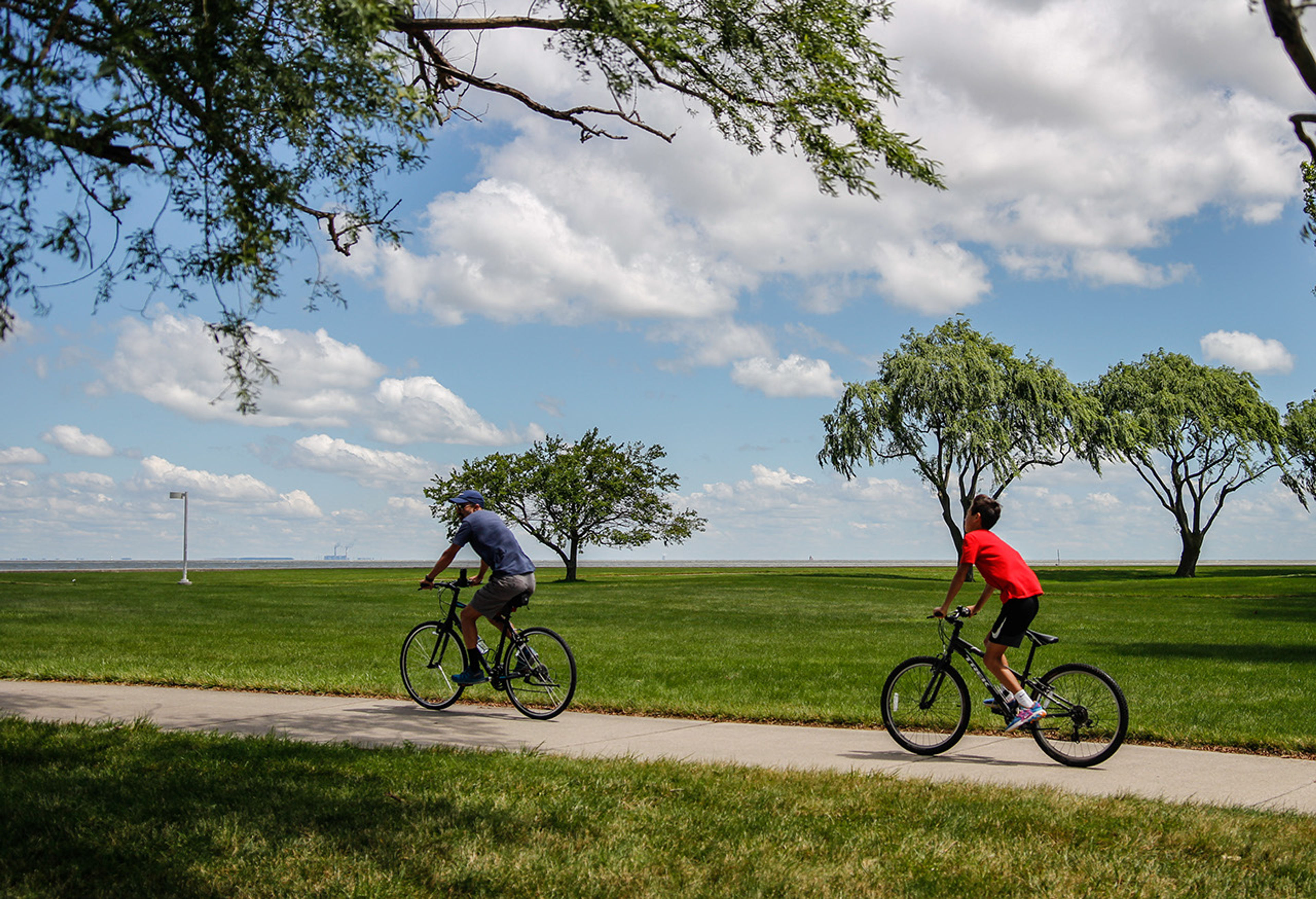 Two people riding bicycles on a path at Maumee Bay State Park