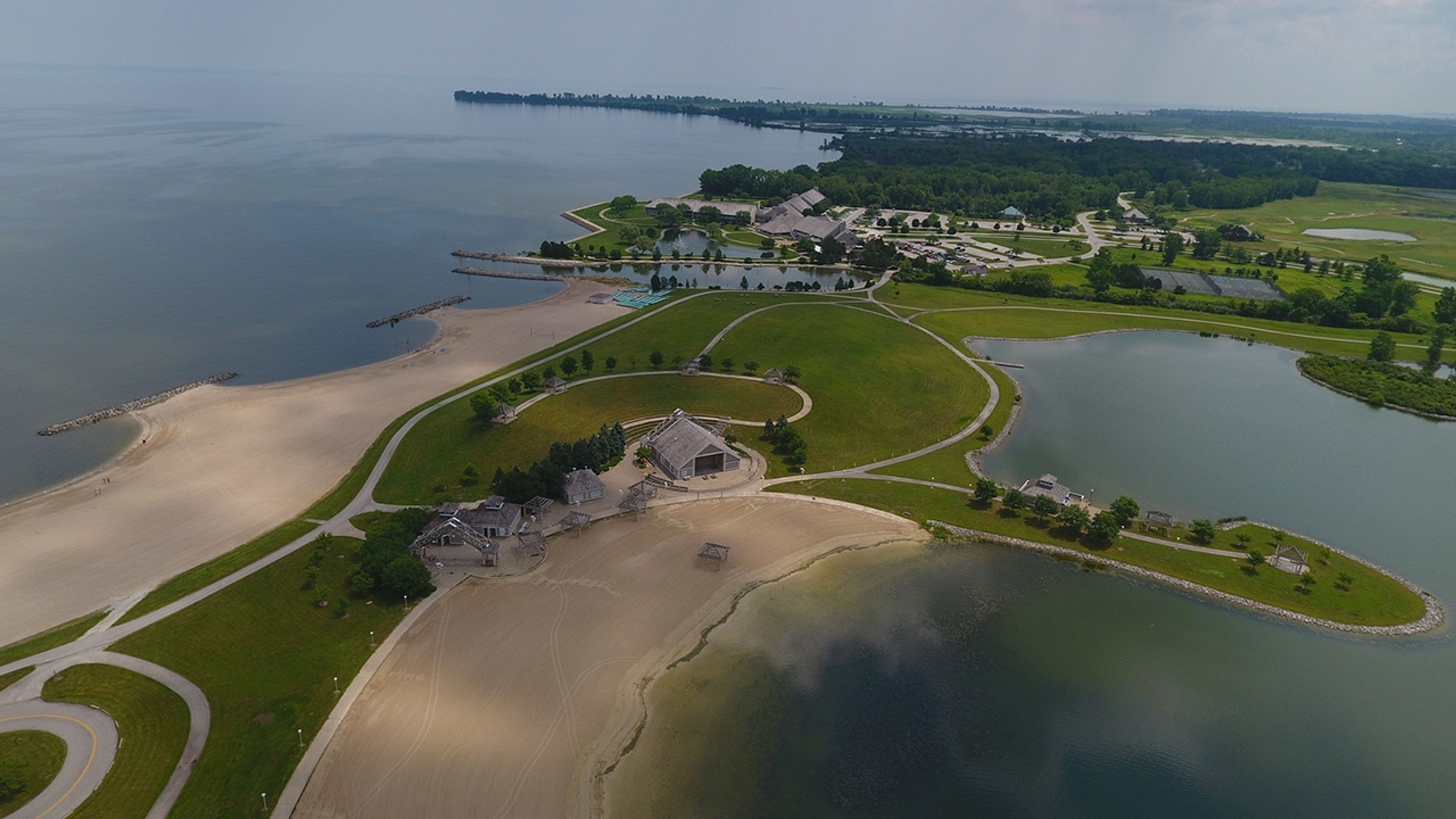 An aerial view of a beach and land at Maumee Bay State Park