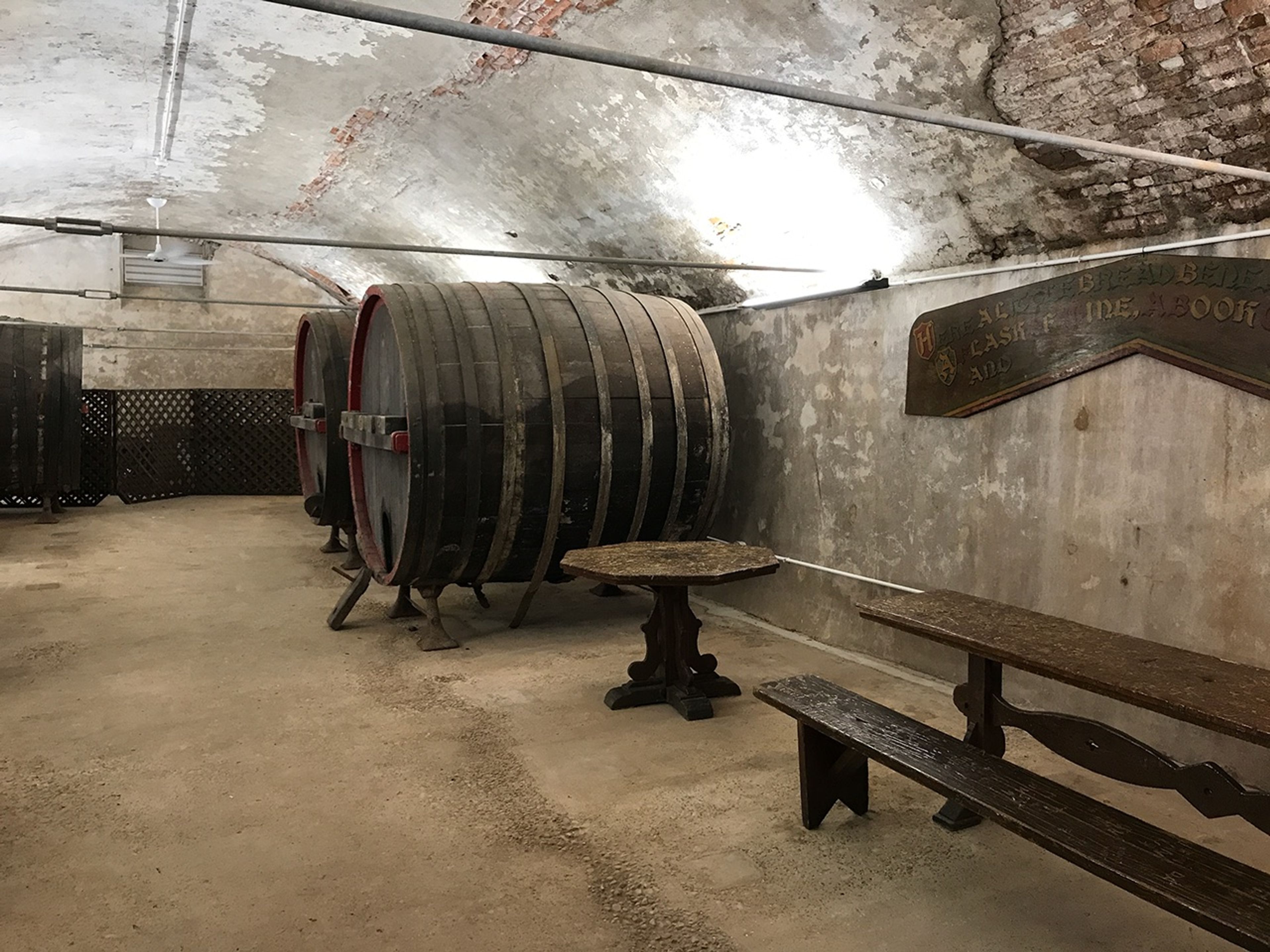 Two tables next to two wine barrels in a cellar at Middle Bass Island State Park