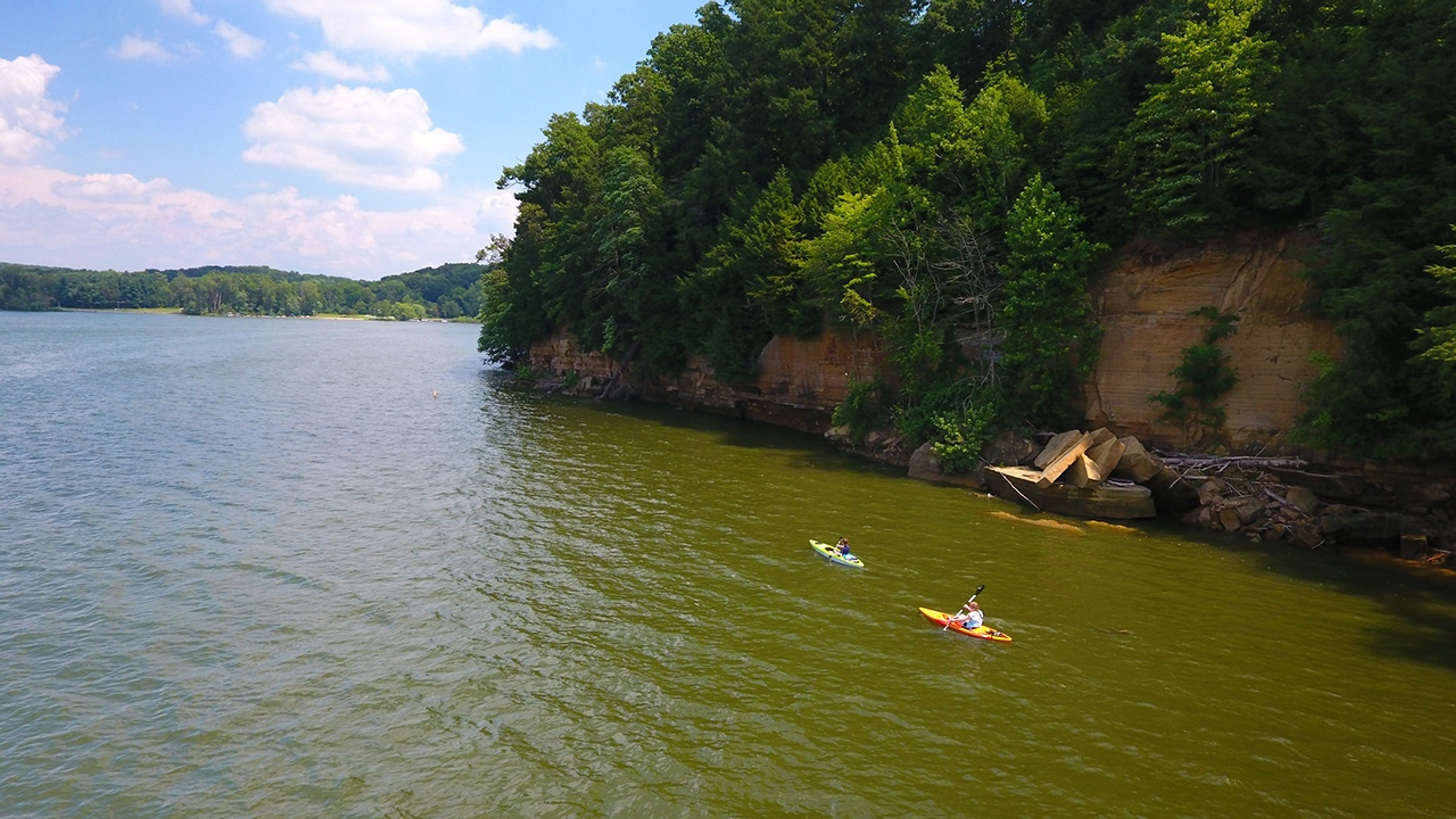 Two people kayaking on a body of water at Mohican State Park