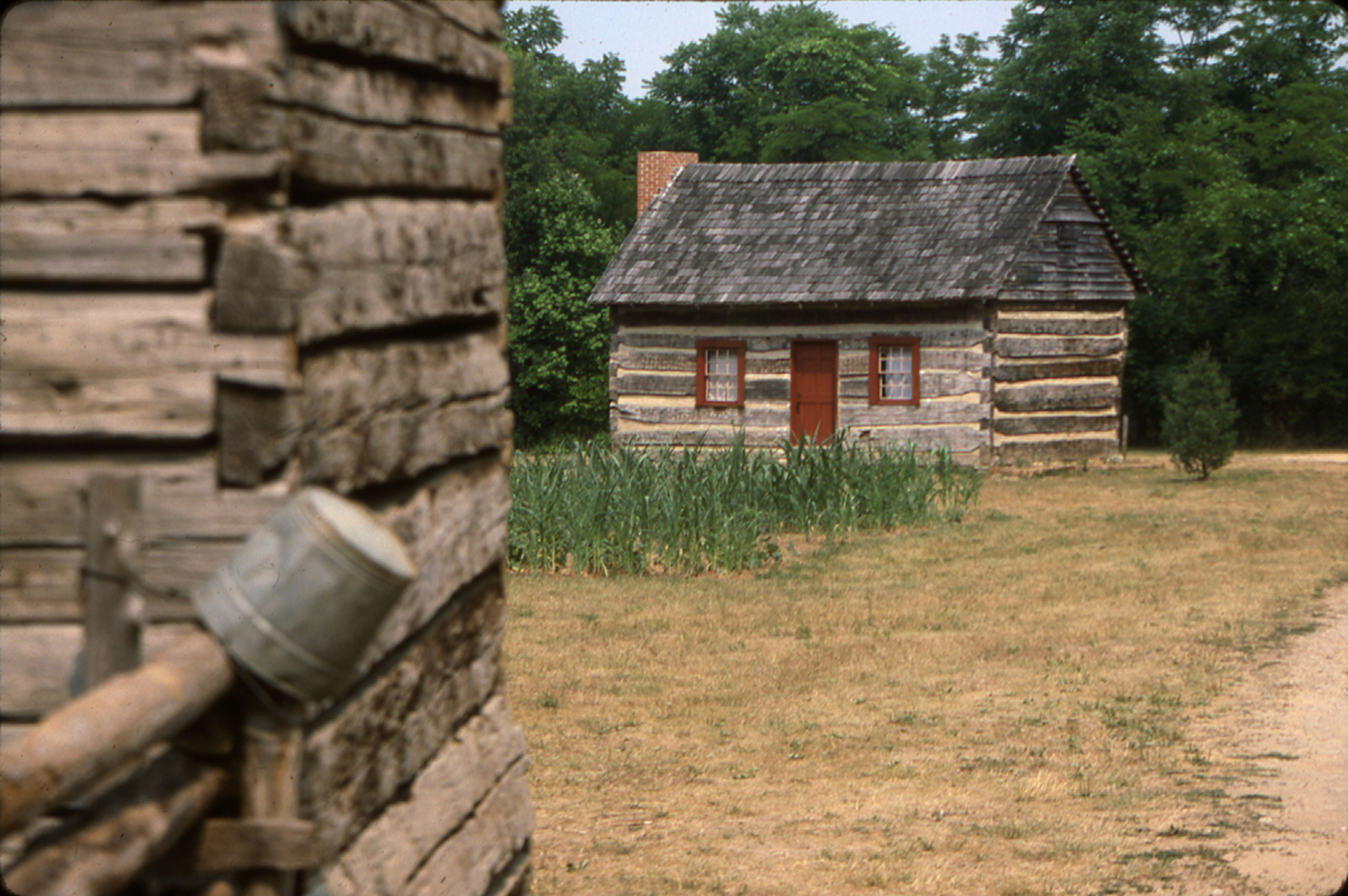 A small log cabin in a field at Paint Creek State Park