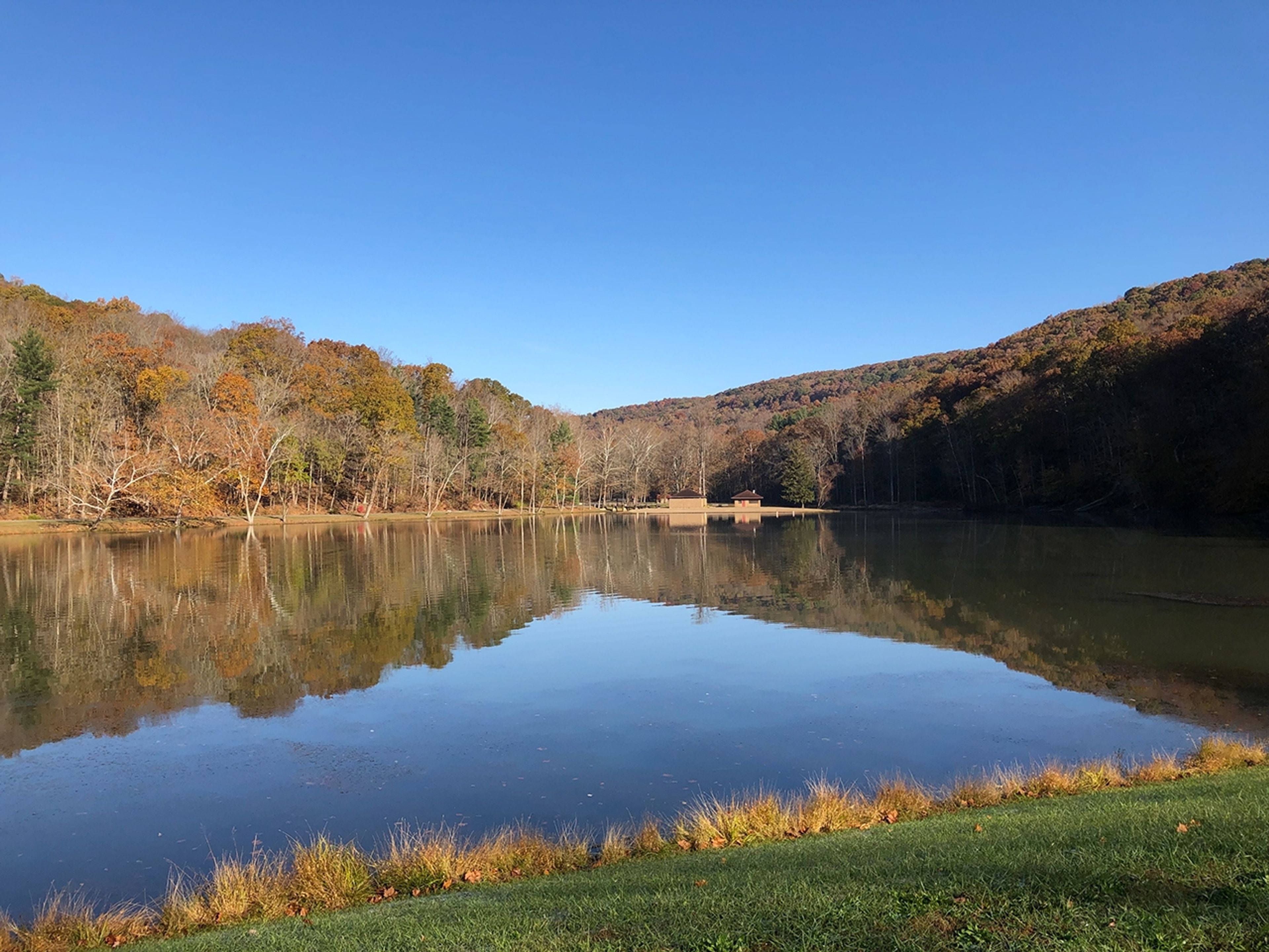 A lake with trees in the background at Pike Lake State Park