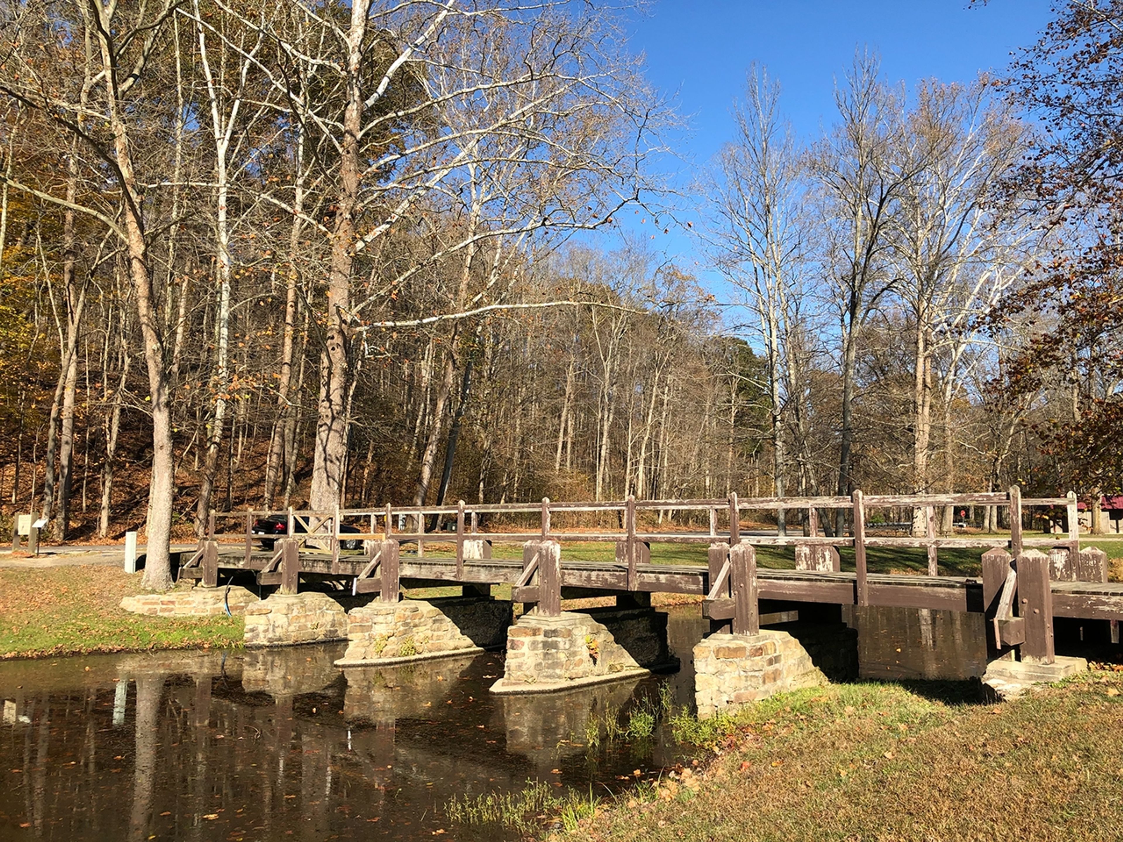 A bridge over water with trees in the background at Pike Lake State Park