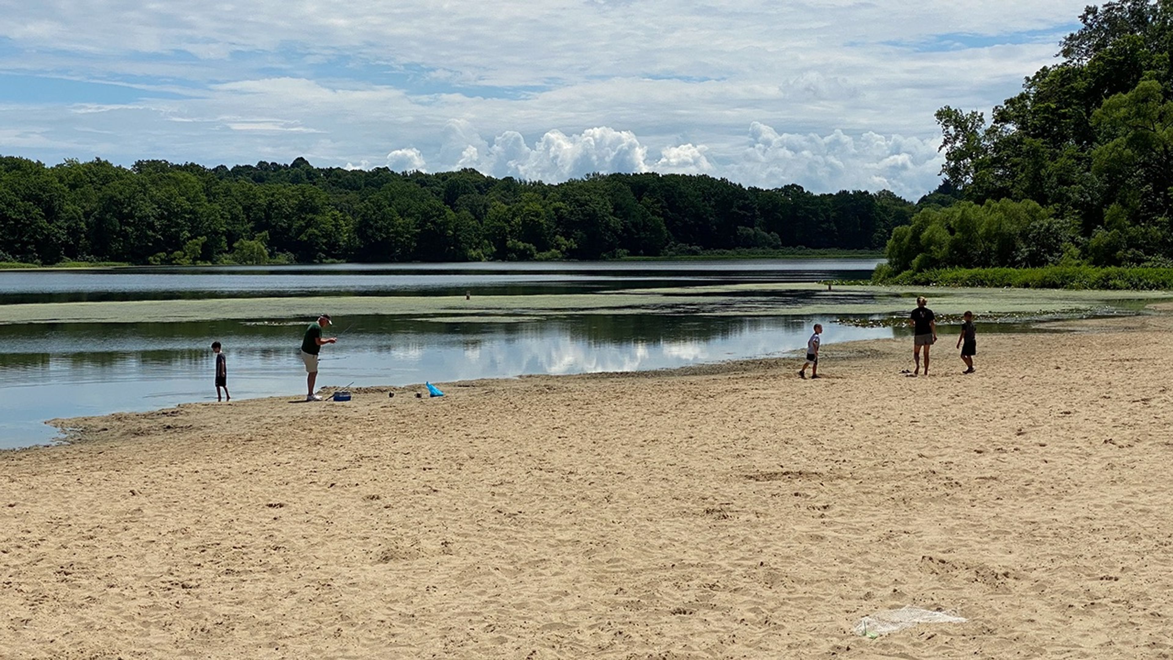 Five people on a beach at Punderson State Park