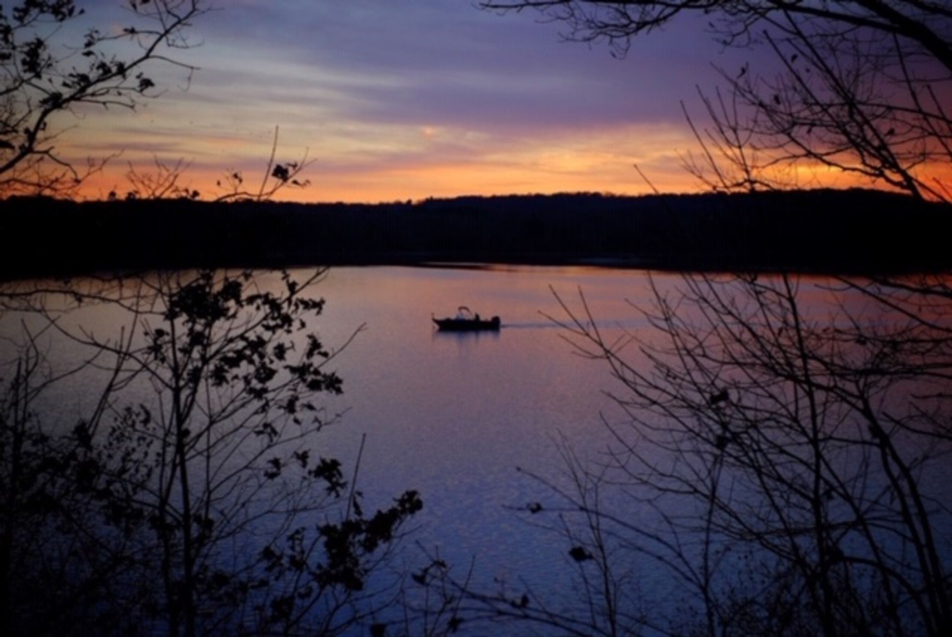 A boat in the water at sunset at West Branch State Park