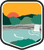 An illustrated badge for the Alabama community showing a waterfall with hills and a sunset in the background.