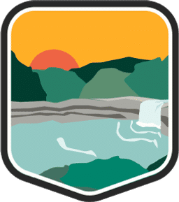 An illustrated badge for the Alabama community showing a waterfall with hills and a sunset in the background.