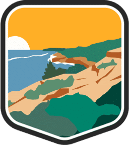 An illustrated badge for the Massachusetts community featuring a rocky, scrub shoreline against the ocean.