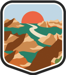 An illustrated badge for the North Dakota community showing a hilly landscape with rock formations and a setting sun.