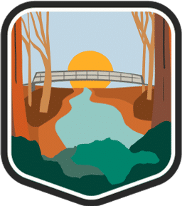 An illustrated badge for the South Carolina community showing a river with cypress trees and a bridge crossing it in a swampy landscape.