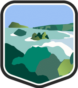 An illustrated badge for the U.S. Virgin Islands community featuring a verdant tropical landscape with a forested shoreline against clear blue water.