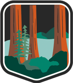 An illustrated badge for the Vermont community showing a forested area with tall pine trees under a night sky.