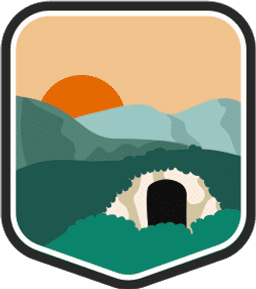 An illustrated badge for the Virginia community featuring a cave entrance with a valley and a setting sun in the background.