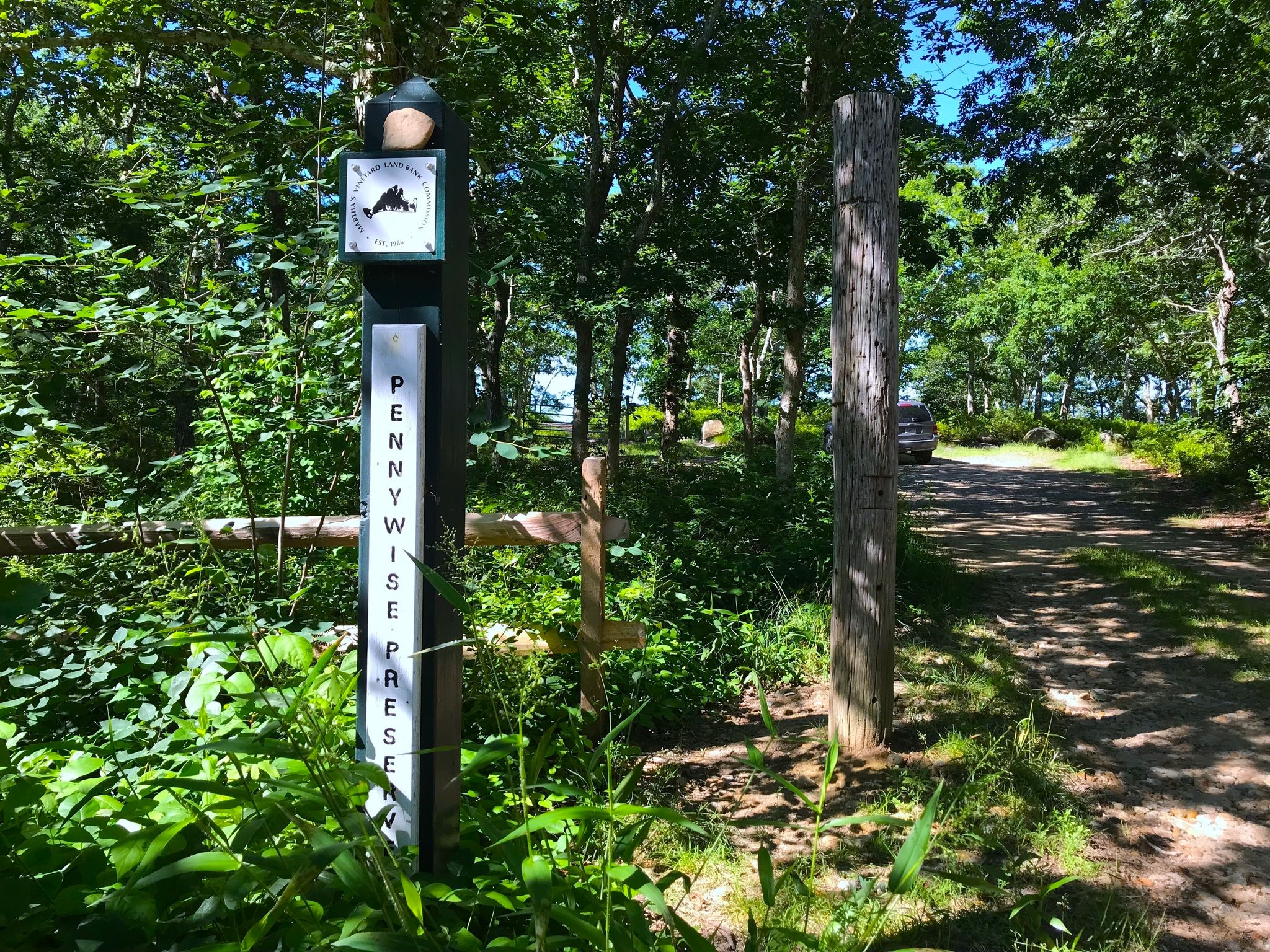 Pennywise Preserve sign with view of the parking lot in the background. Enter the Pennywise Path on the left.